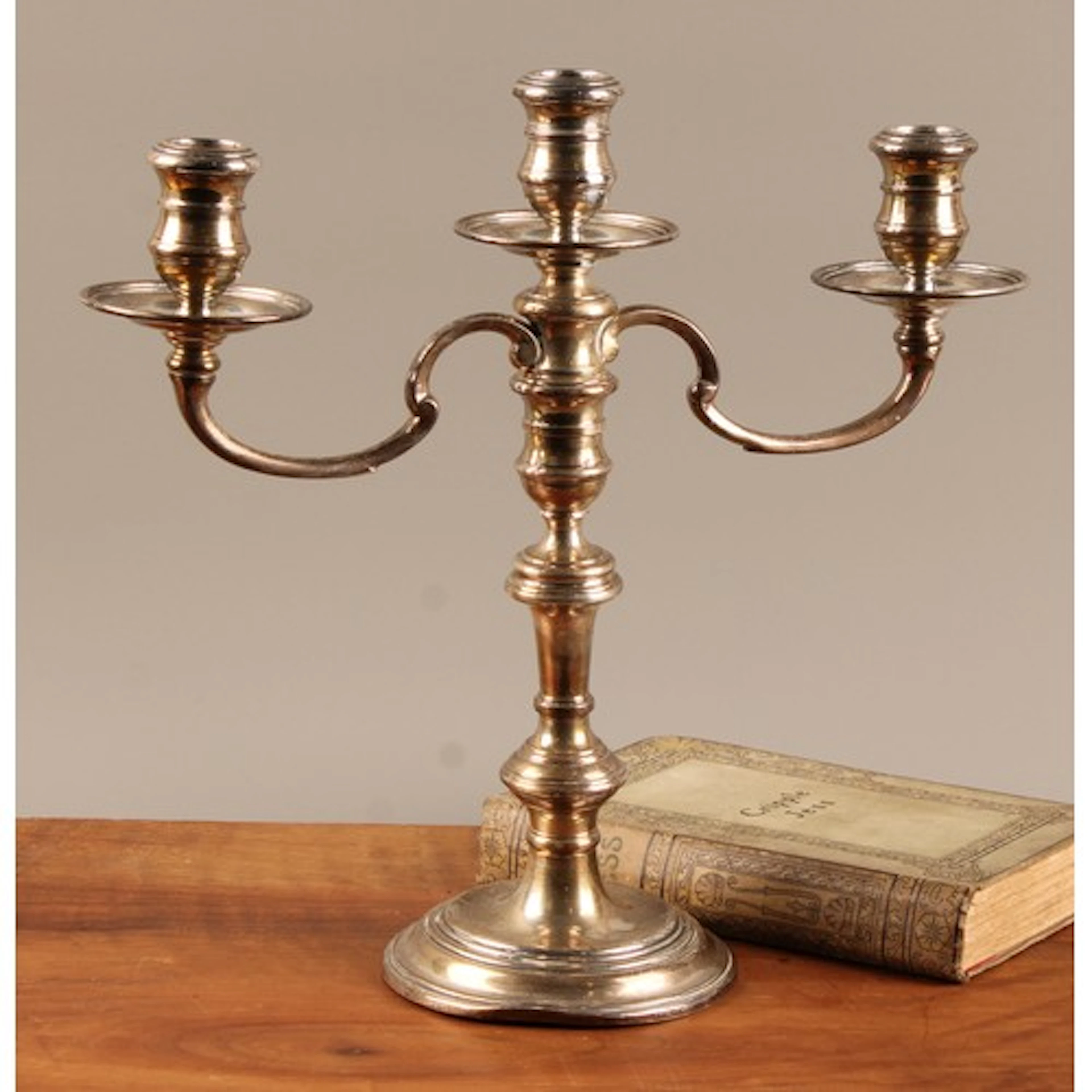 An Elizabeth II silver three-light table candelabrum, waiste...