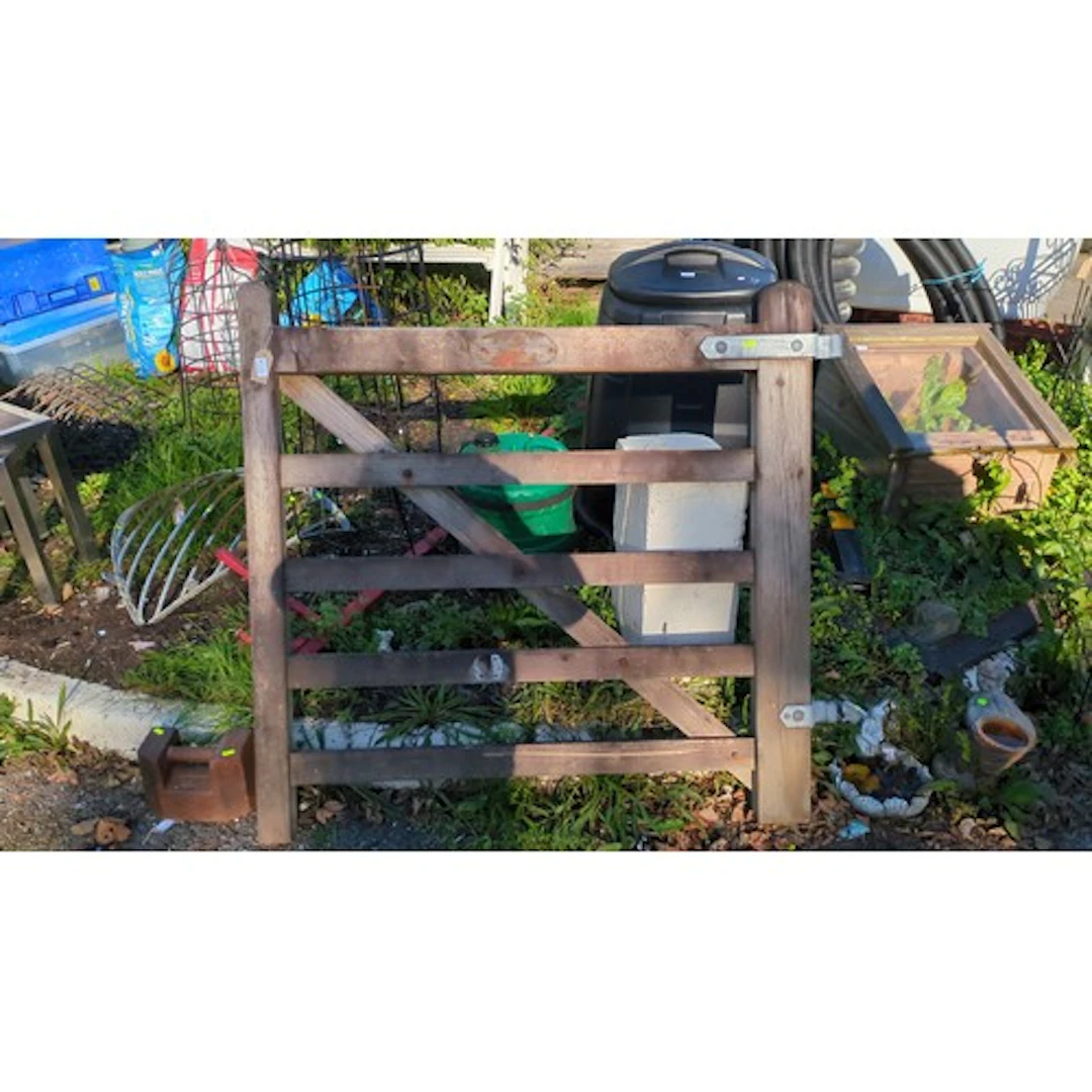 Timber five-bar field gate with diagonal bracing, rounded st...