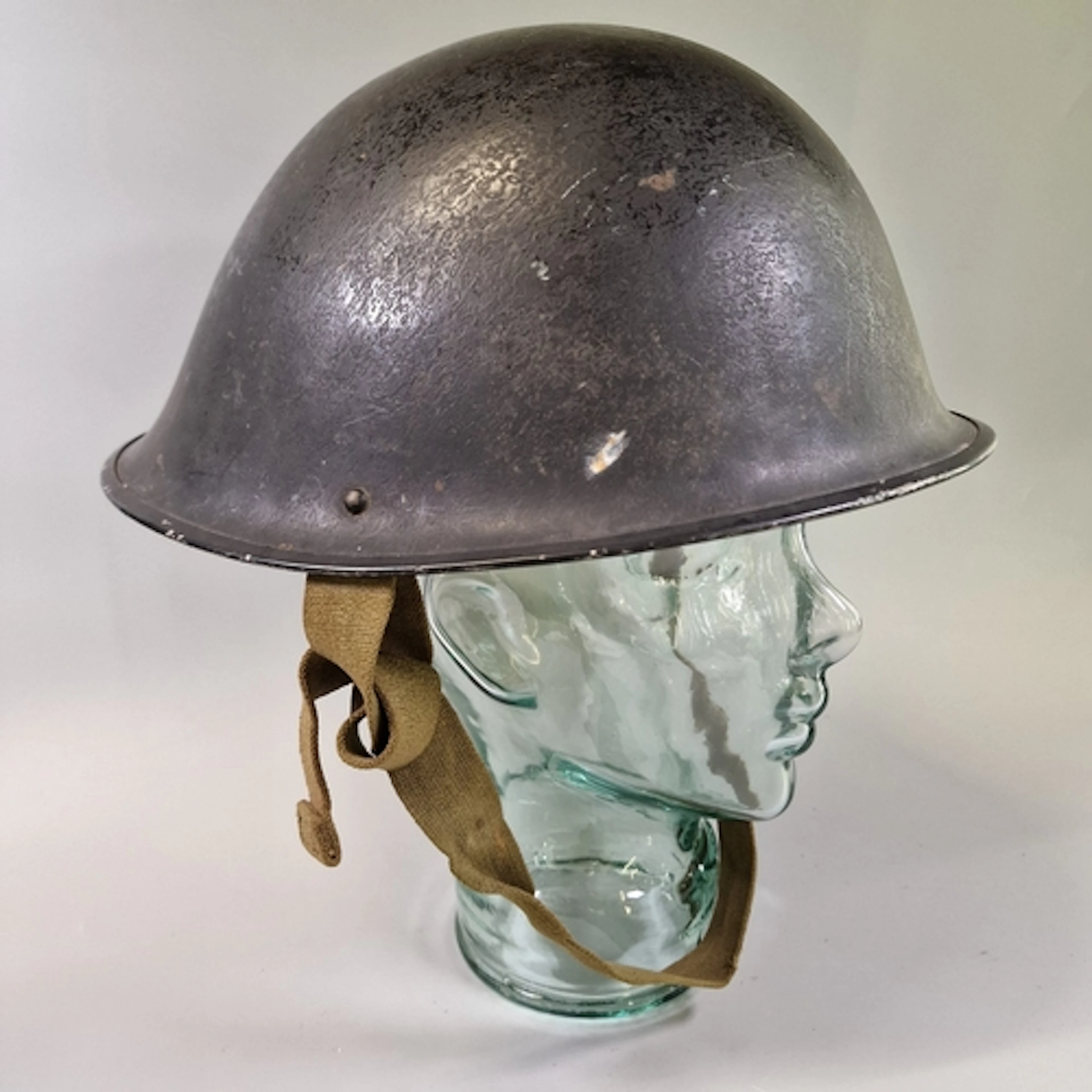 British Mk IV ‘turtle’ helmet, painted black, with size 7 li...