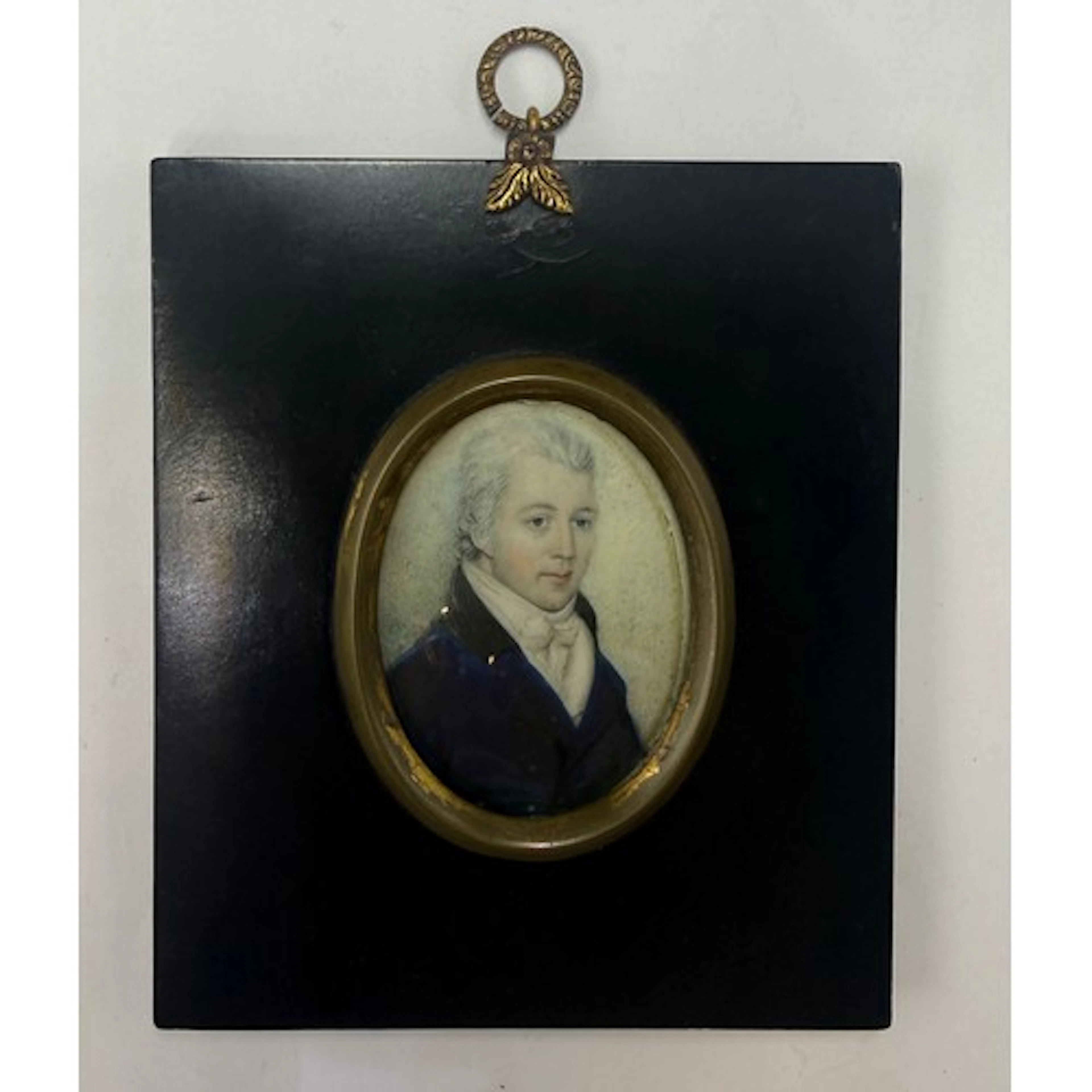 A painted miniature on ivory depicting a gentleman in blue t...
