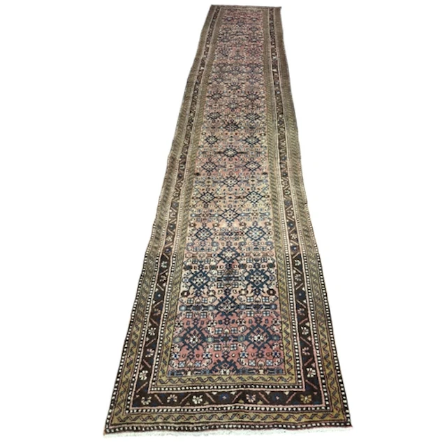 A large and impressive Persian Hamadan runner, with a washed...