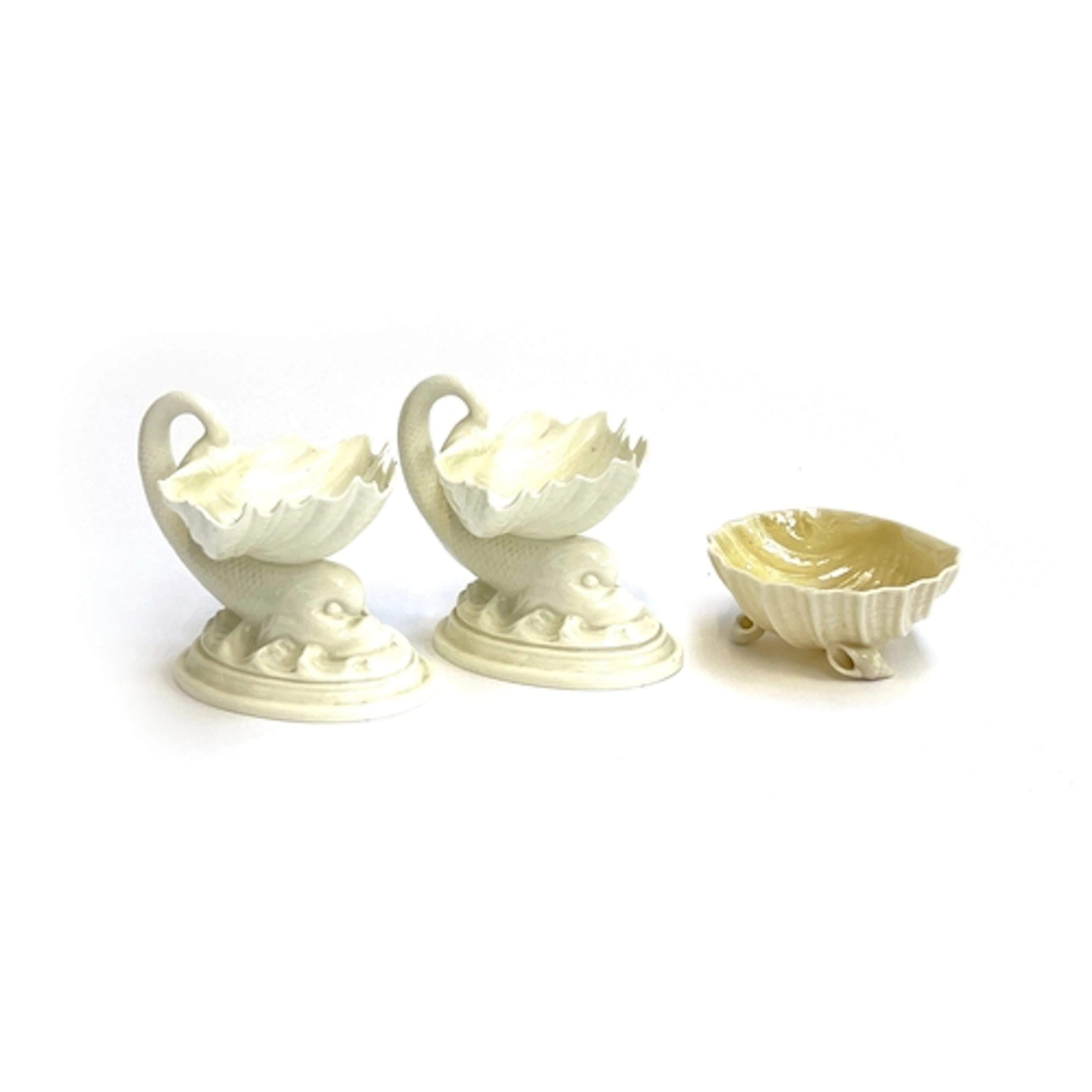 A pair of Royal Worcester salts formed as classical dolphins...