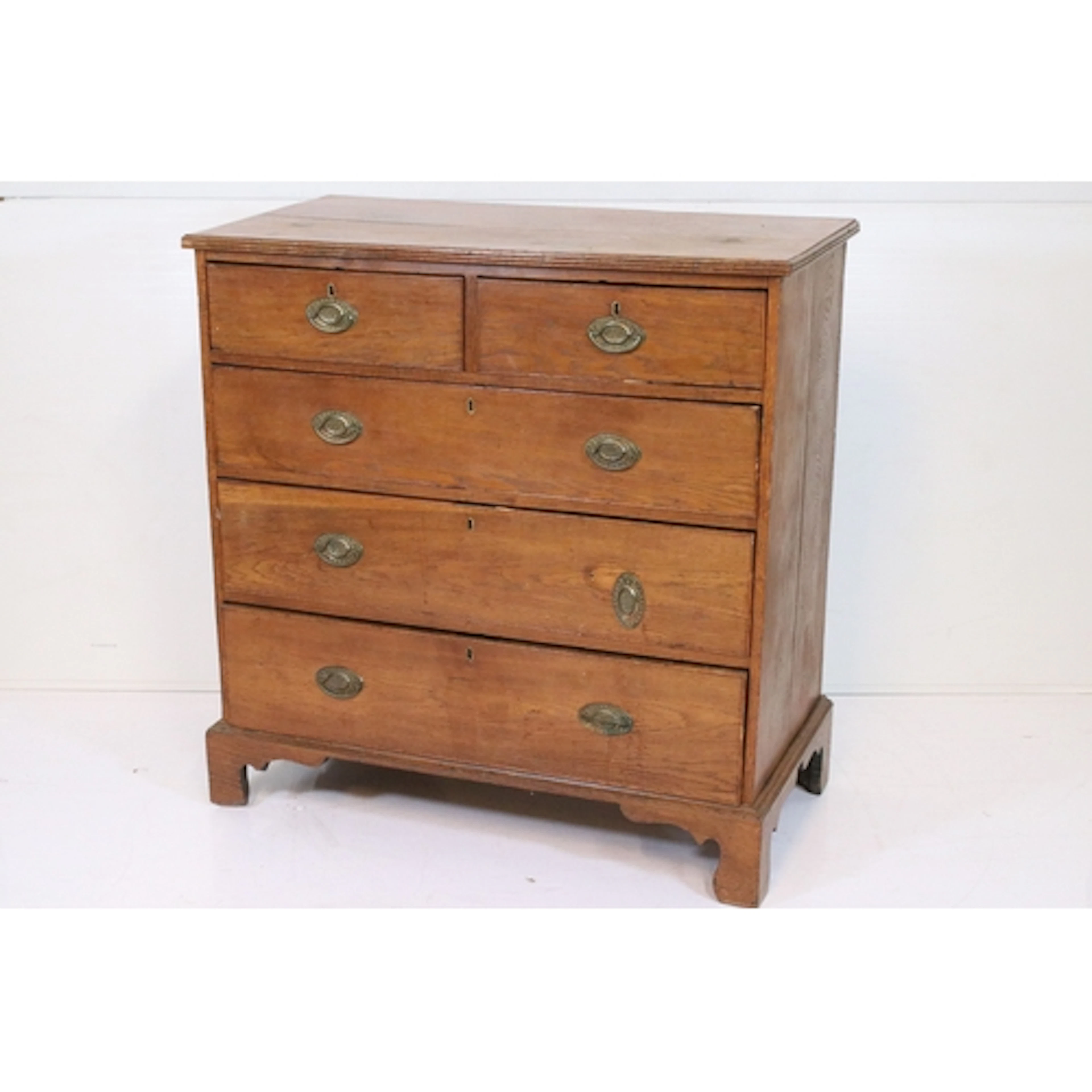 Georgian oak chest of drawers, housing two short on three lo...