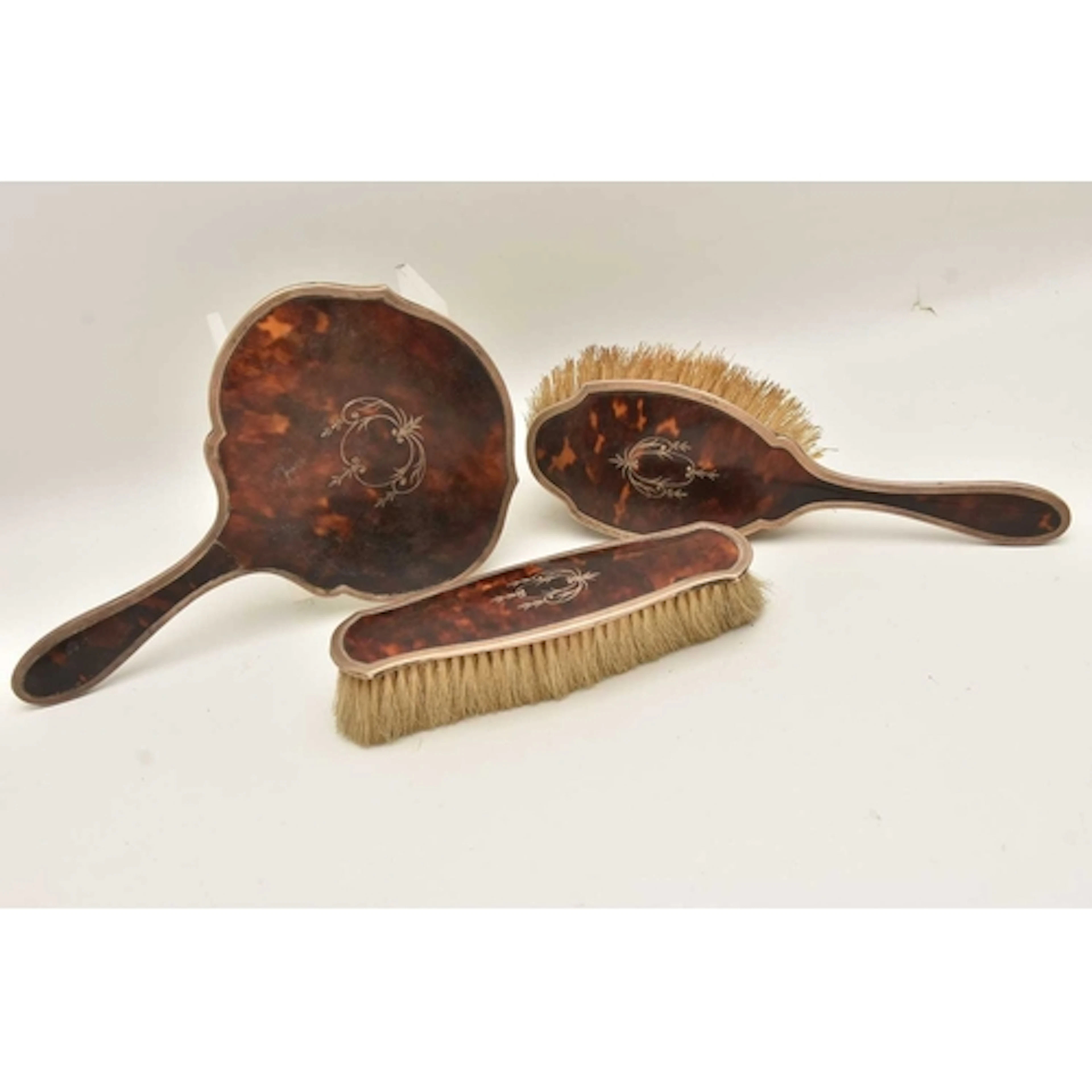 A SILVER VANITY SET, to include a hand held mirror, a hair b...