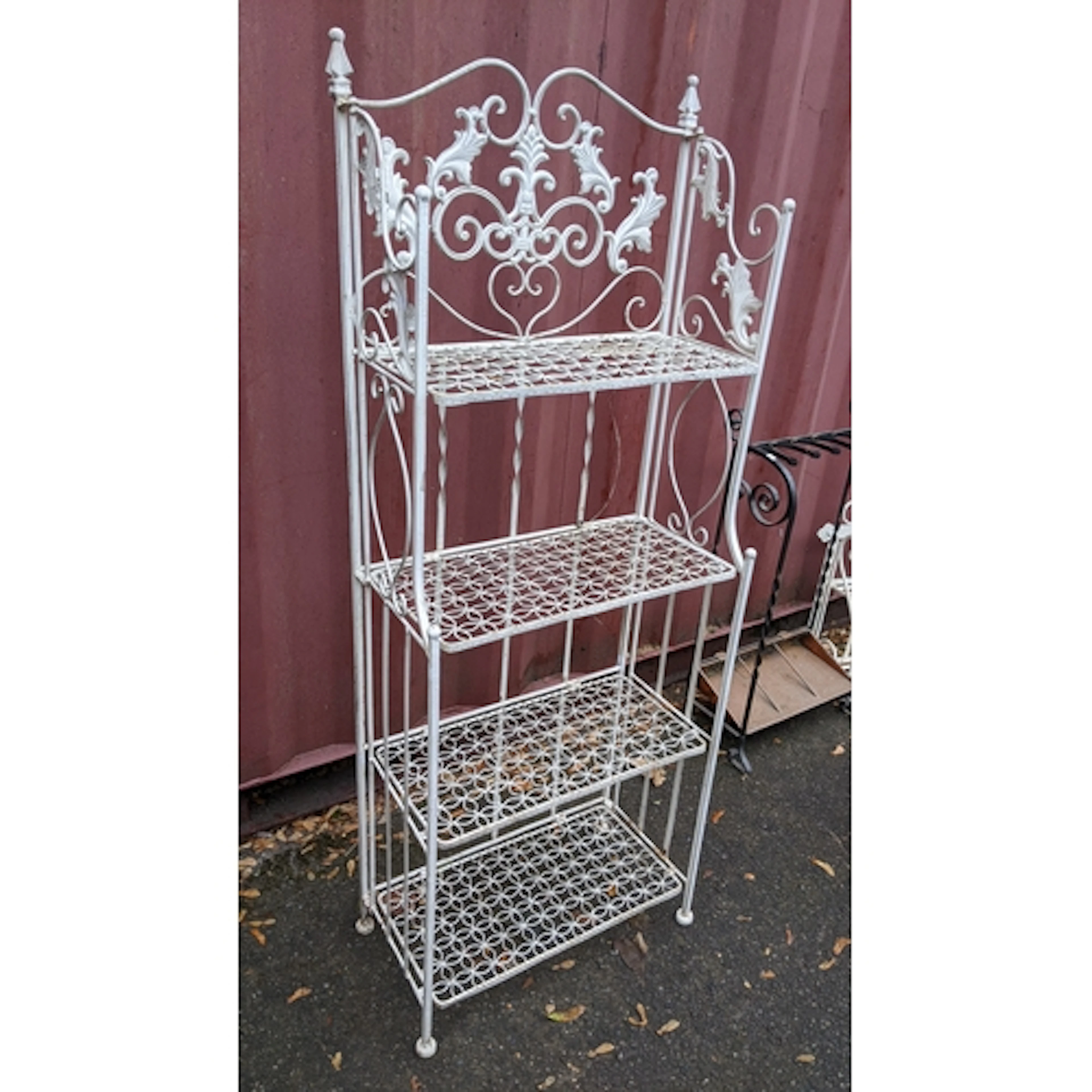 A vintage white painted cast iron folding four tier garden p...