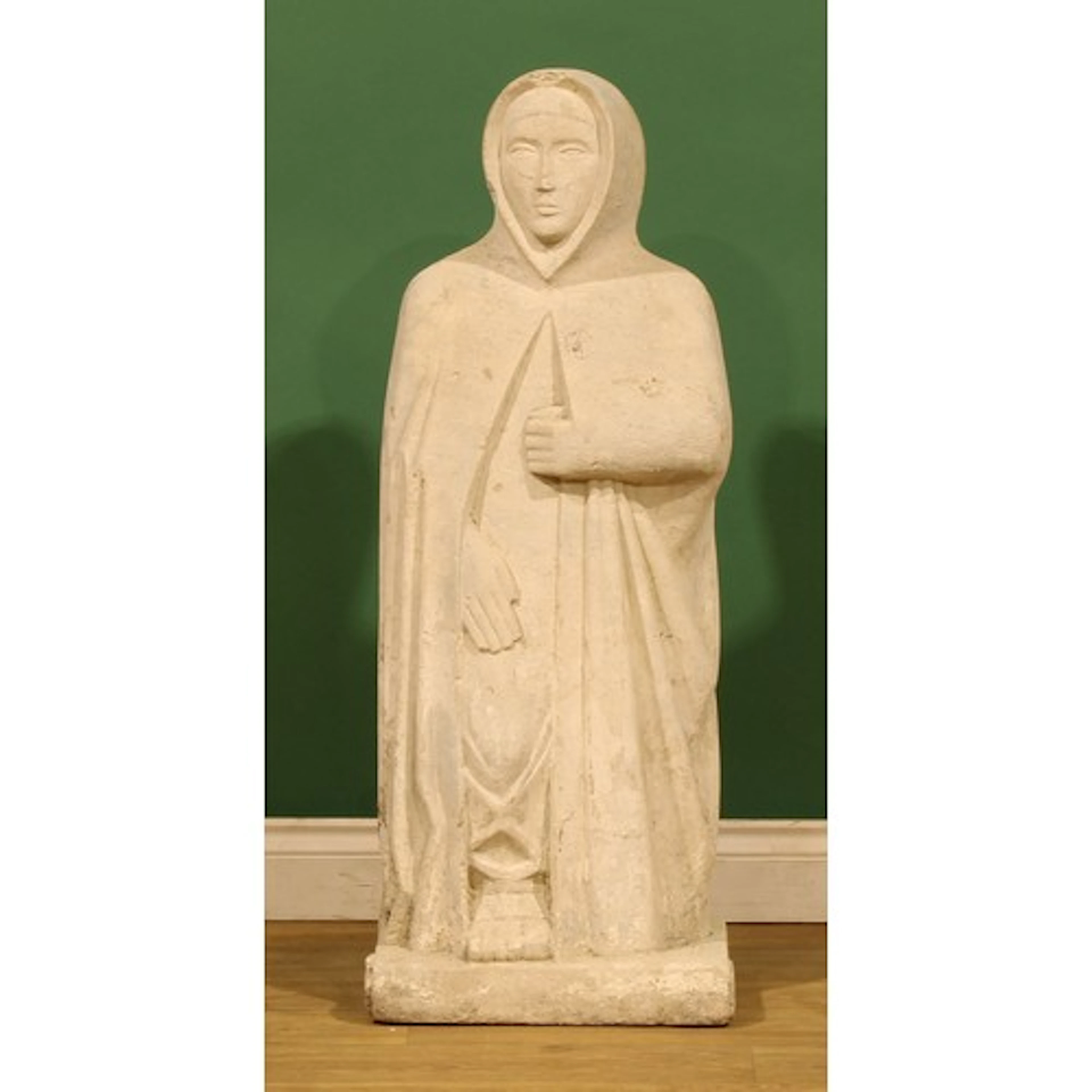 A Romanesque Revival stone carving, of a female saint, proba...