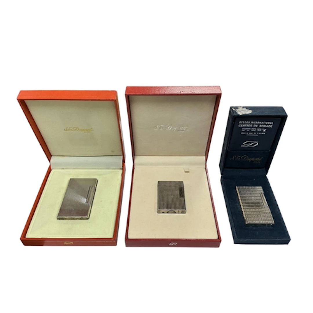 S.T. Dupont, three silver-plated lighters, each stamped to t...
