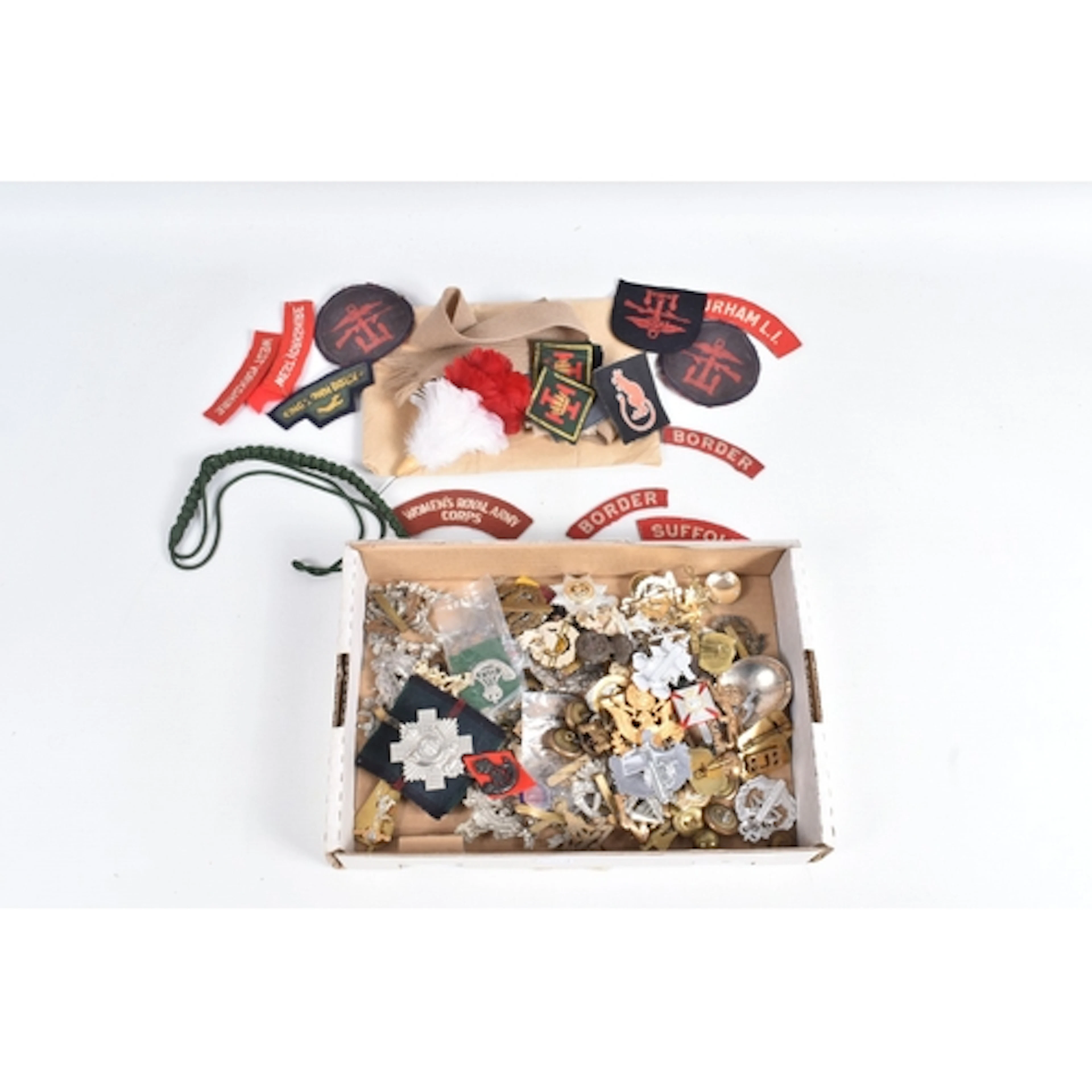 A TIN CONTAINING MILITARY CAP BADGES, FORMATION AND SHOULDER...