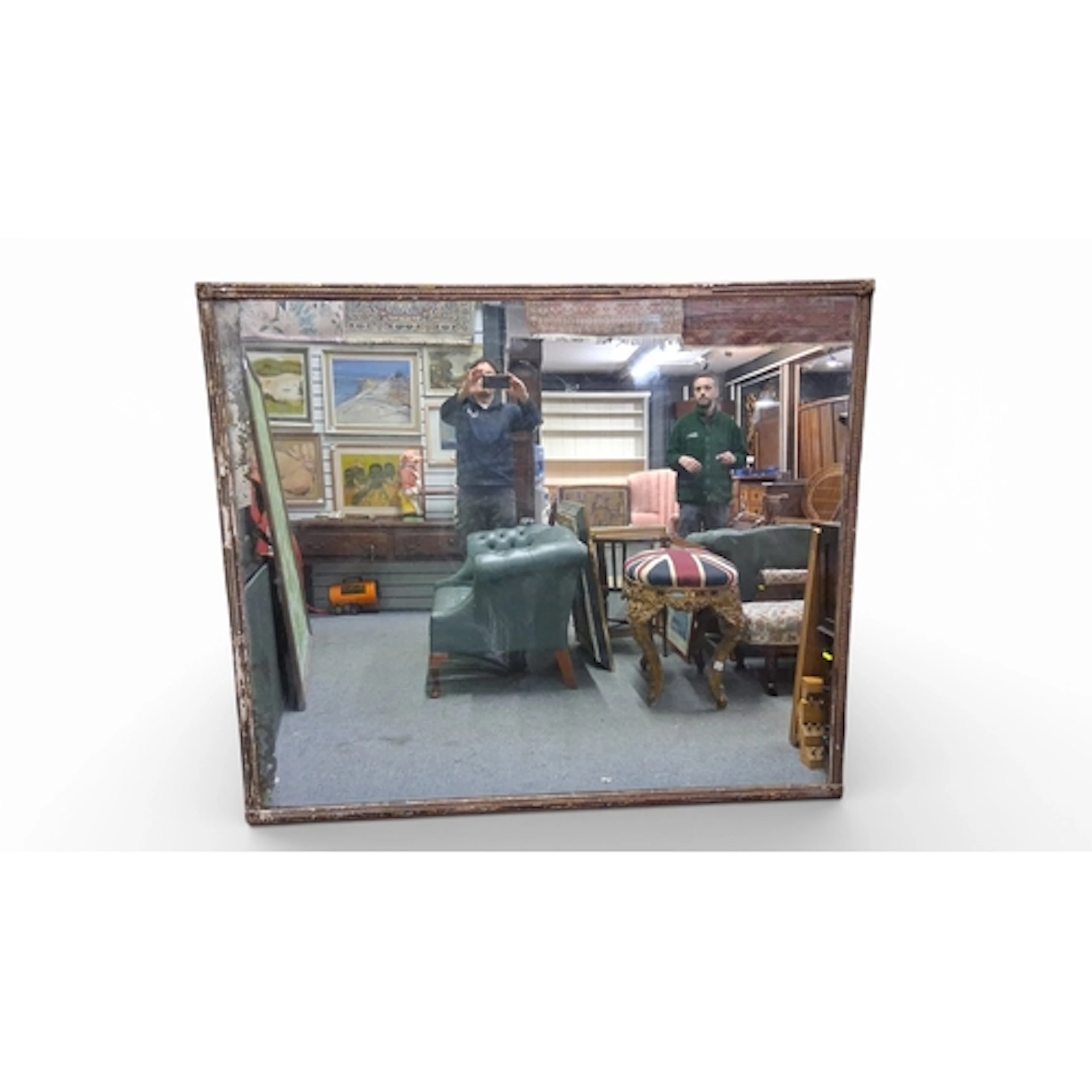A large, heavy rectangular wall mirror in a moulded and gess...