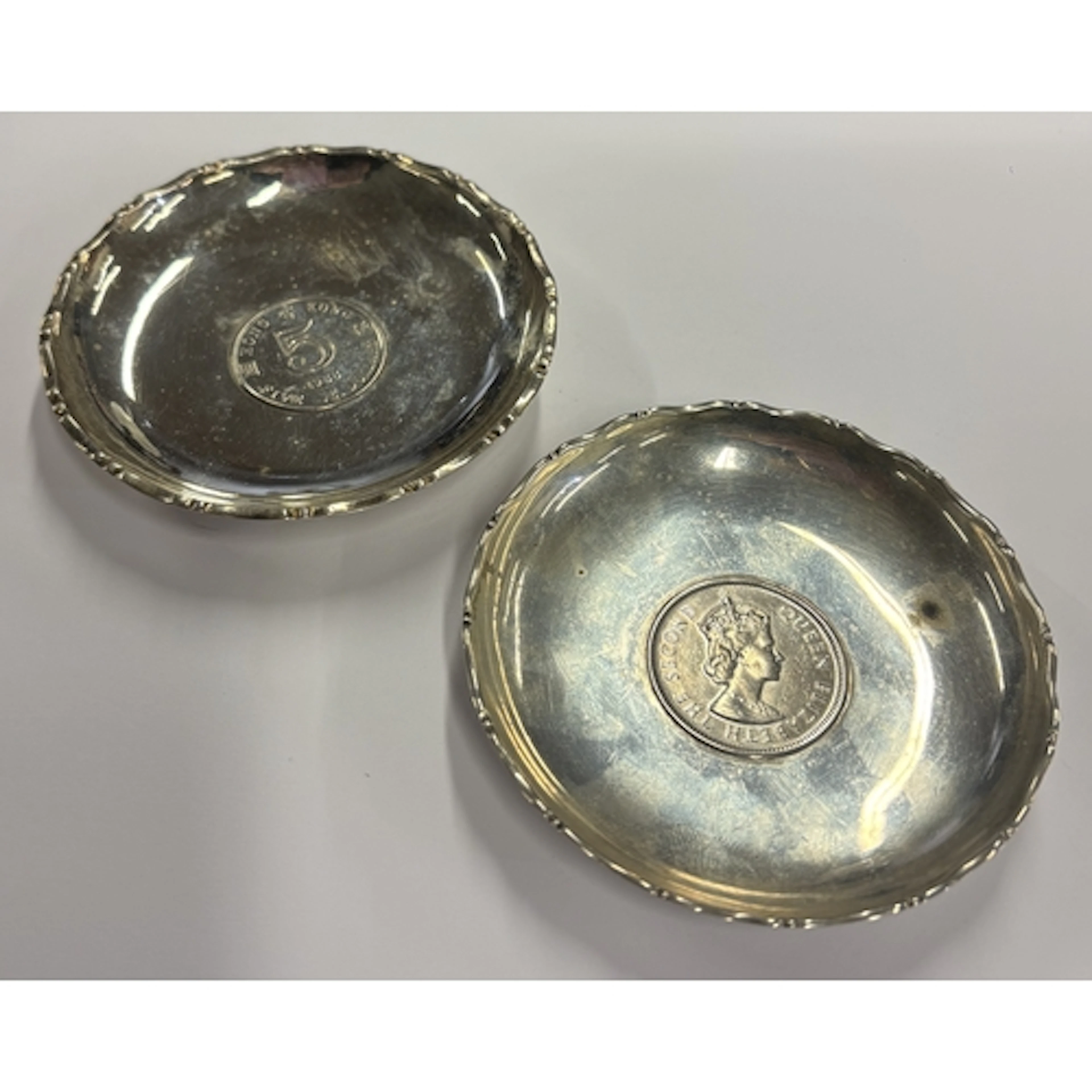 A pair of small Chinese silver pin dishes set with coins. Ap...