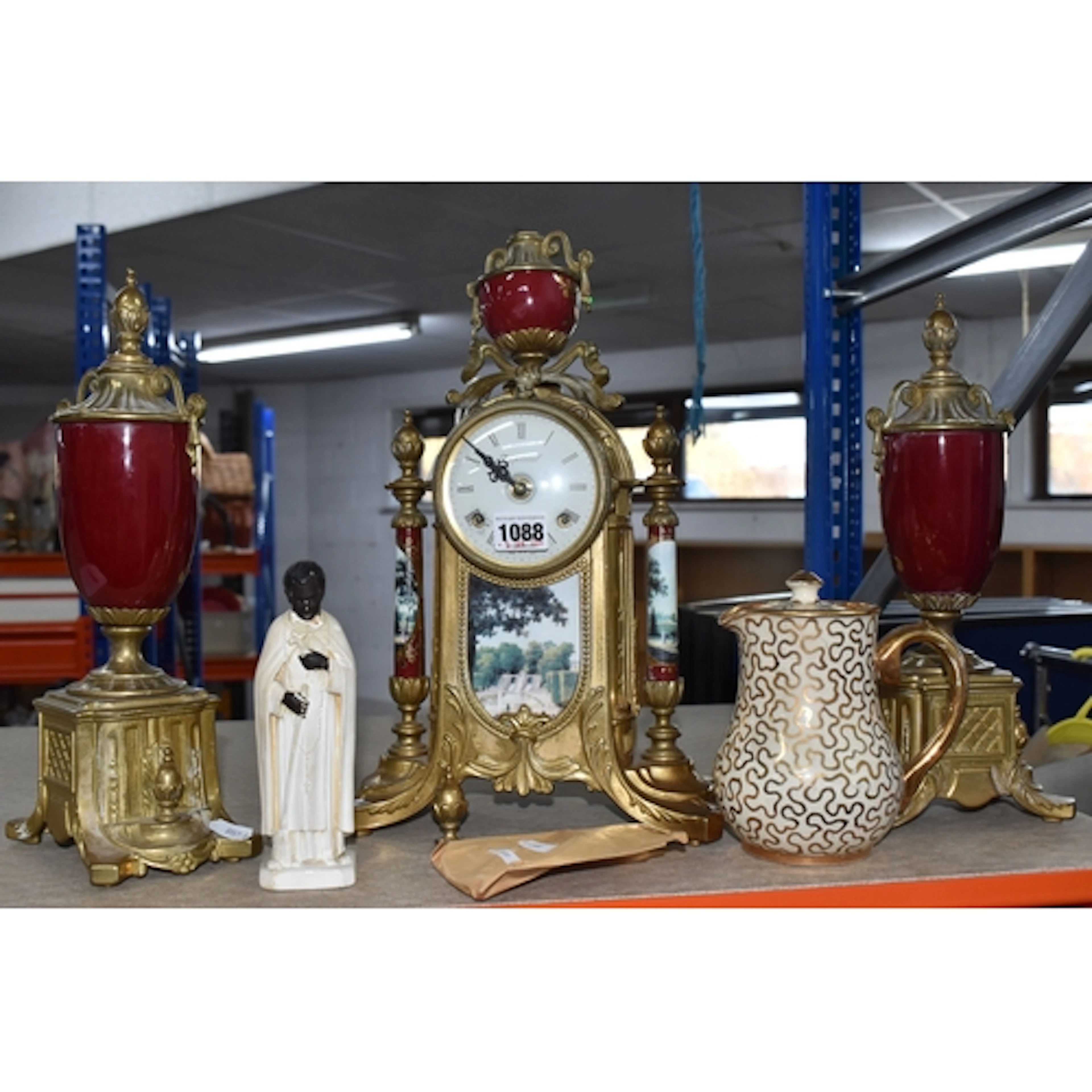 A BRASS AND PORCELAIN CLOCK GARNITURE, signed Imperial to th...