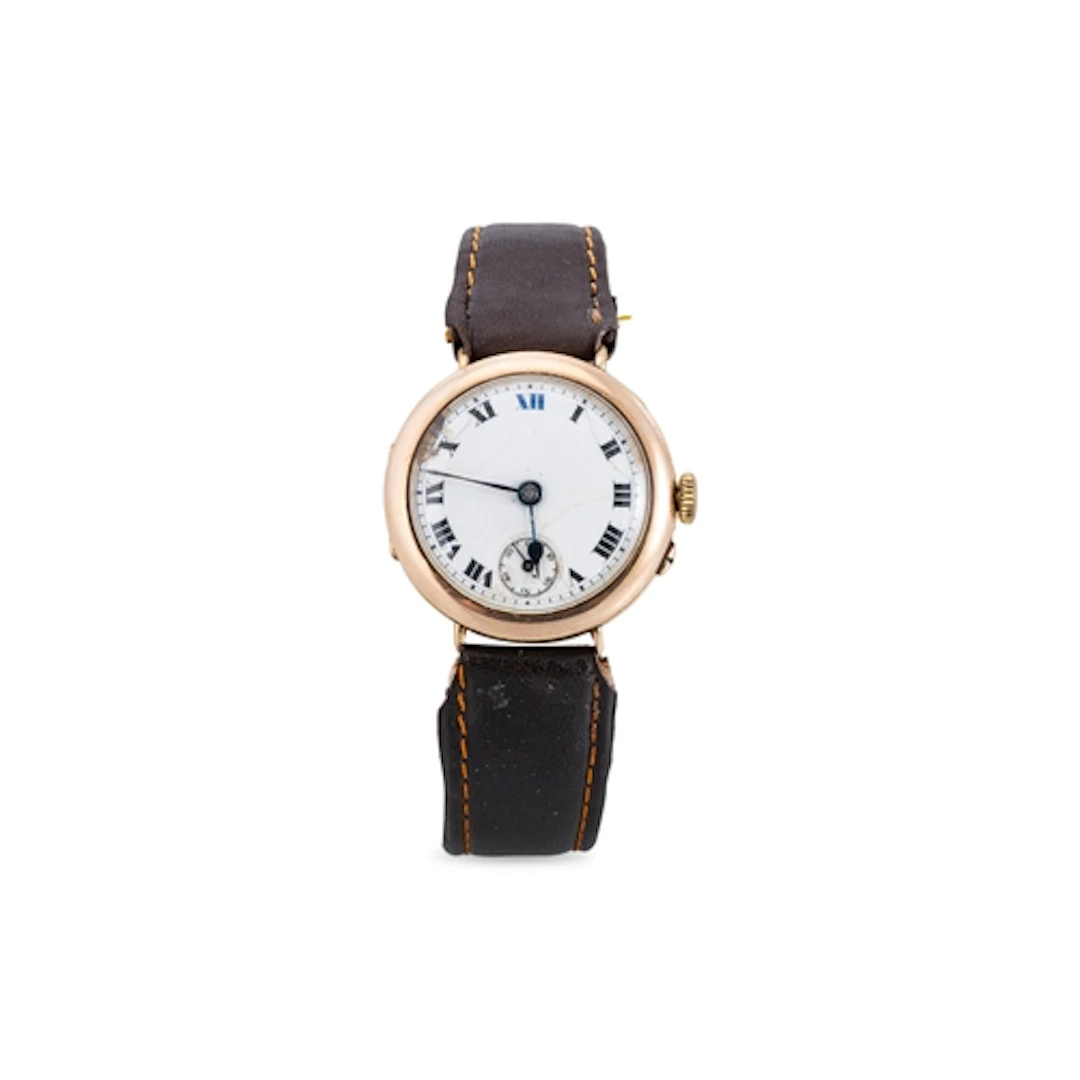 A 1920's TRENCH STYLE WRIST WATCH, brown leather strap, Roma...