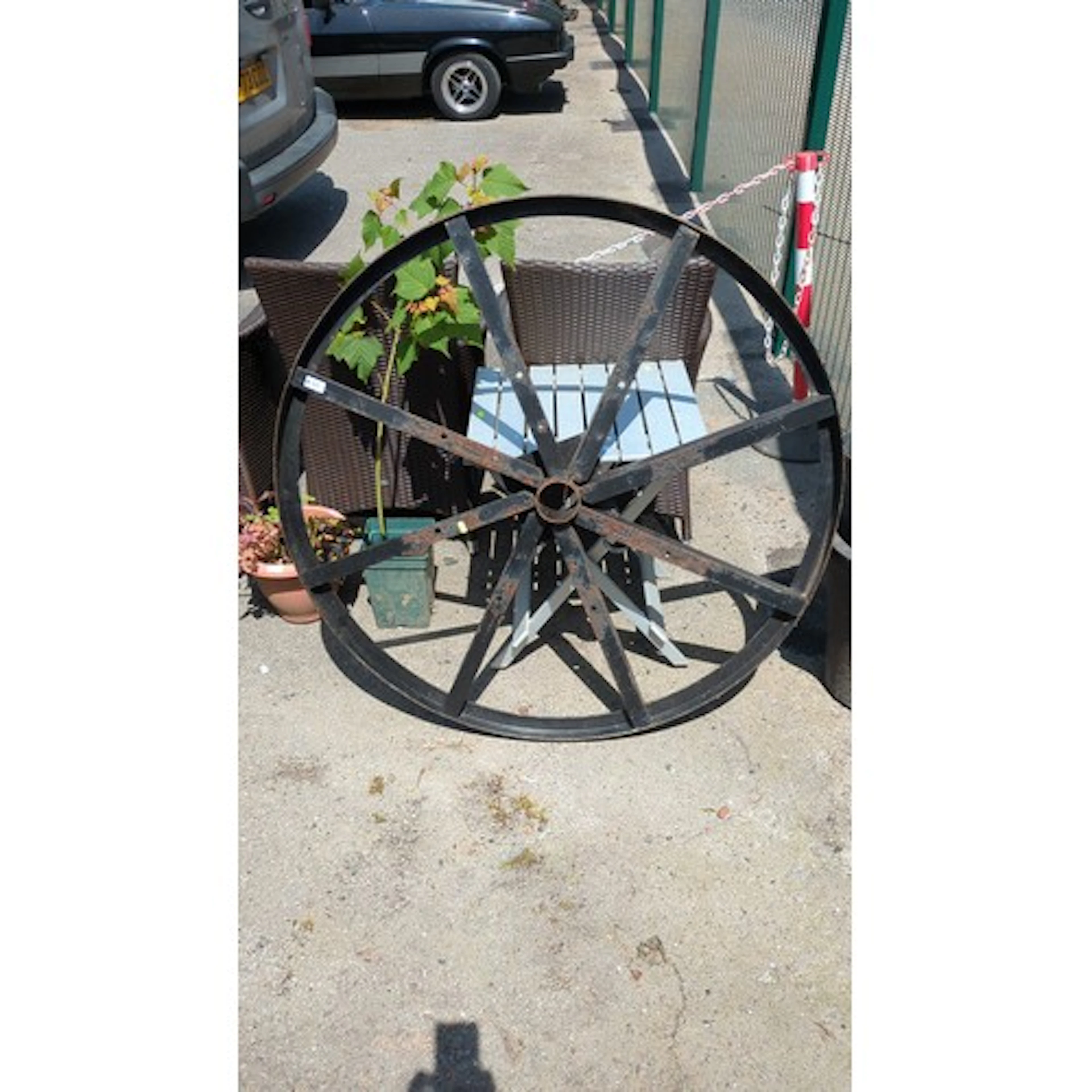 Large wrought-iron cartwheel, of banded rim with eight flat-...