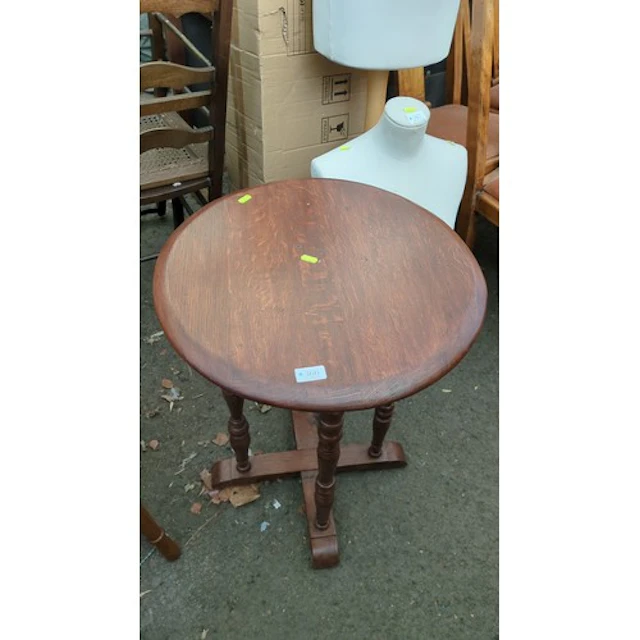 Circular oak occasional table with a moulded edge.
