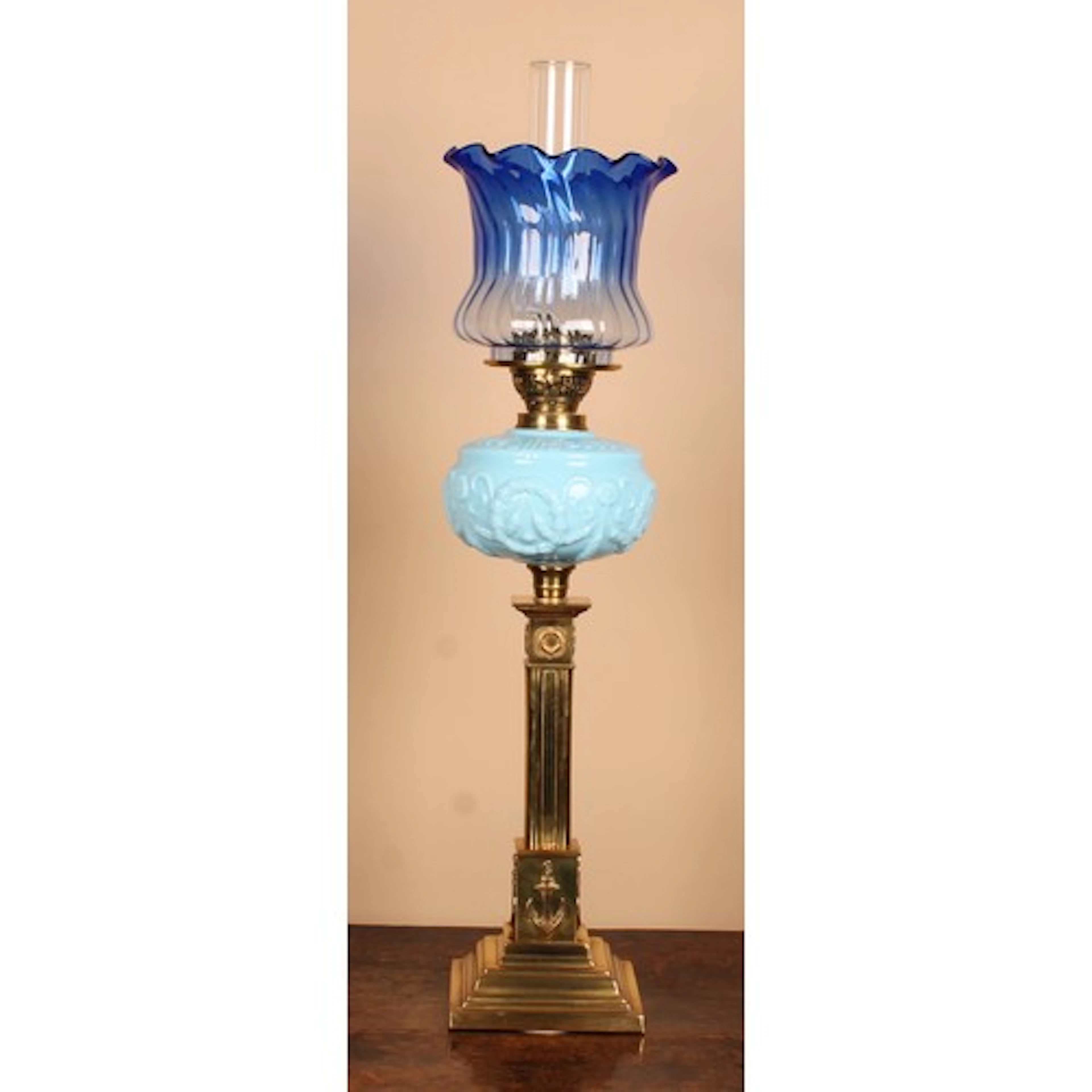 A Victorian brass oil lamp, graduated blue glass frill top s...