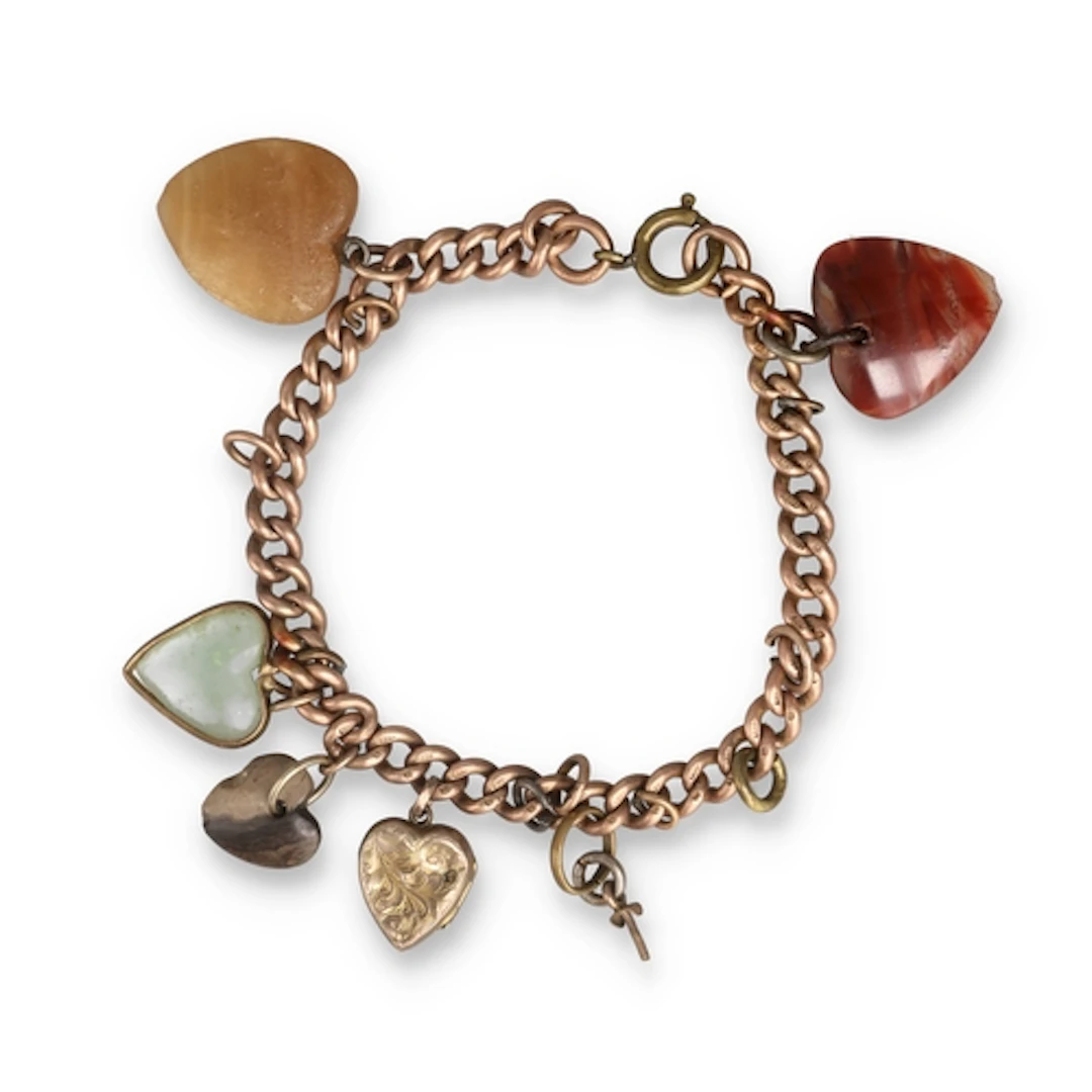 A 9CT GOLD CHARM BRACELET The charms of various stones. Gros...