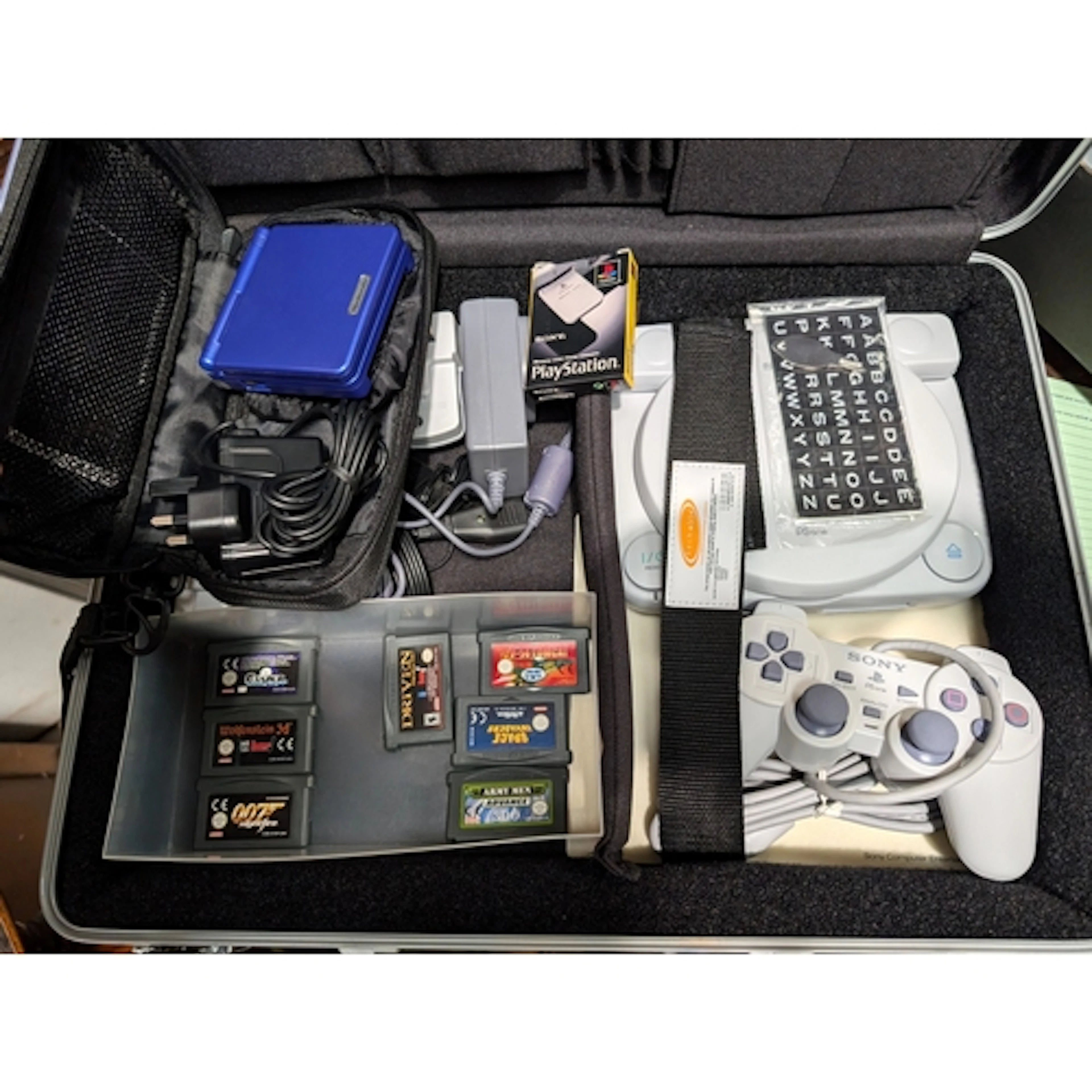 A vintage Travel PS one in case and a Gameboy Advance Sp and...