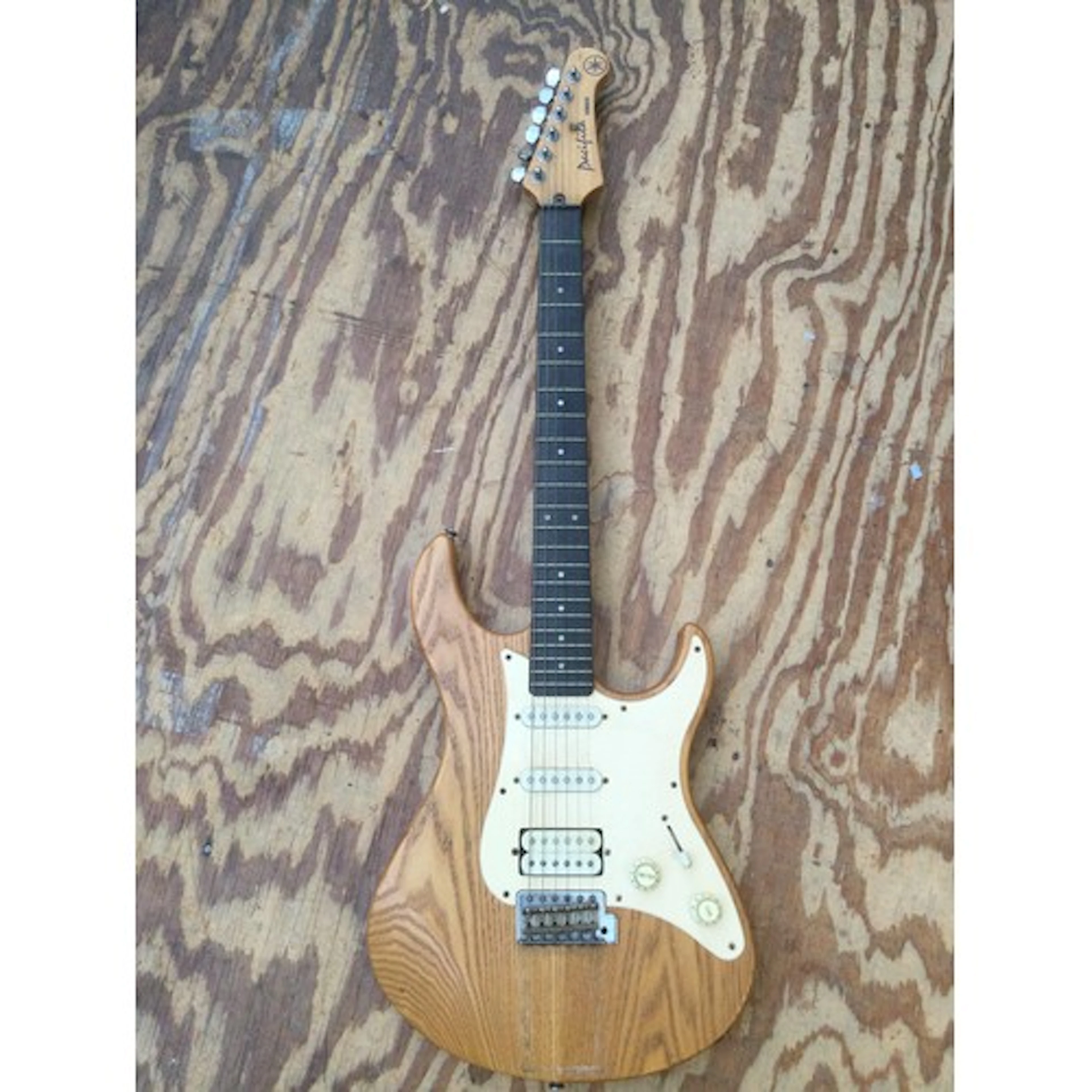 A Yamaha Pacifica electric guitar. No case.