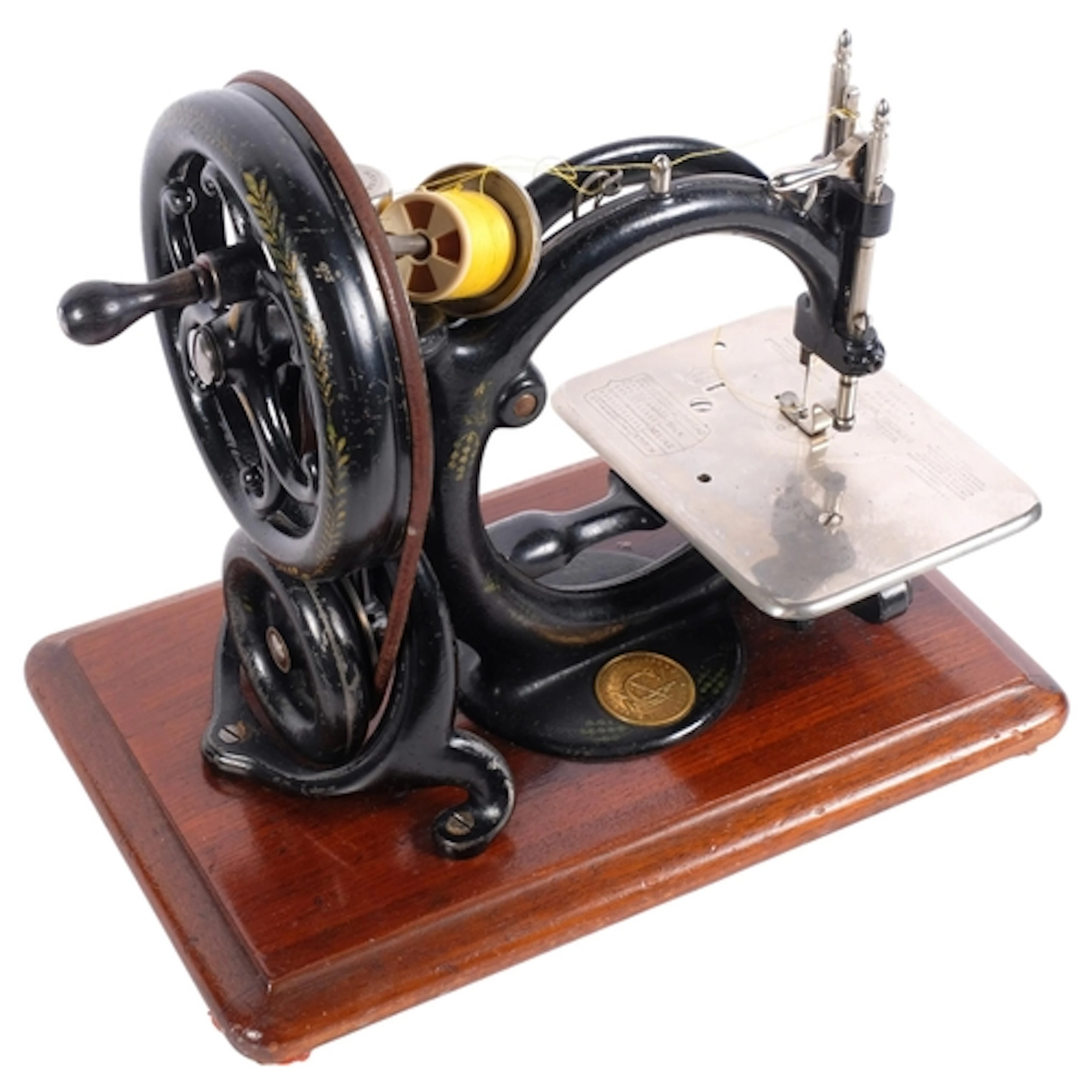 A small Antique Willcox & Gibbs hand sewing machine, on oak ...