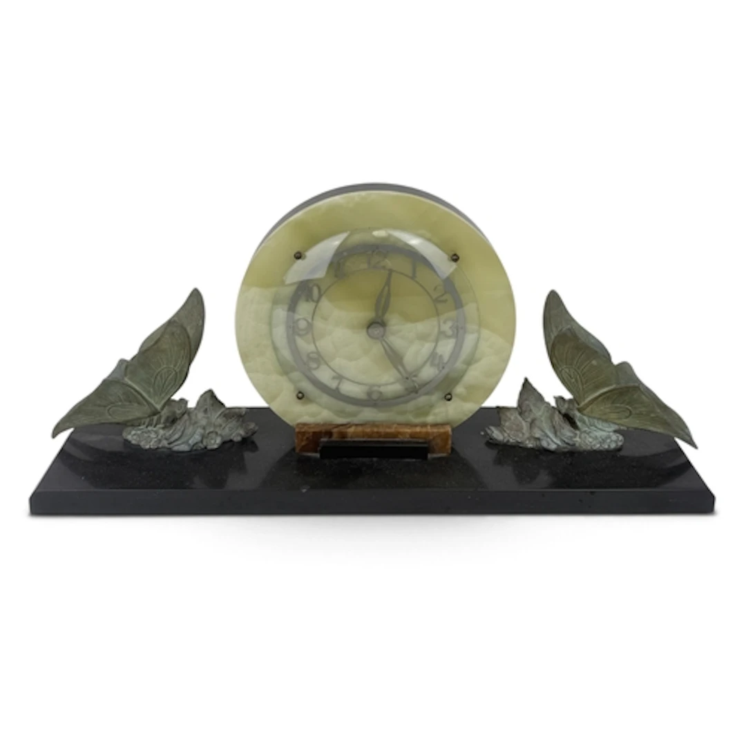 AN ART DECO ONYX MANTLE CLOCK WITH SPELTER BUTTERFLIES On a ...