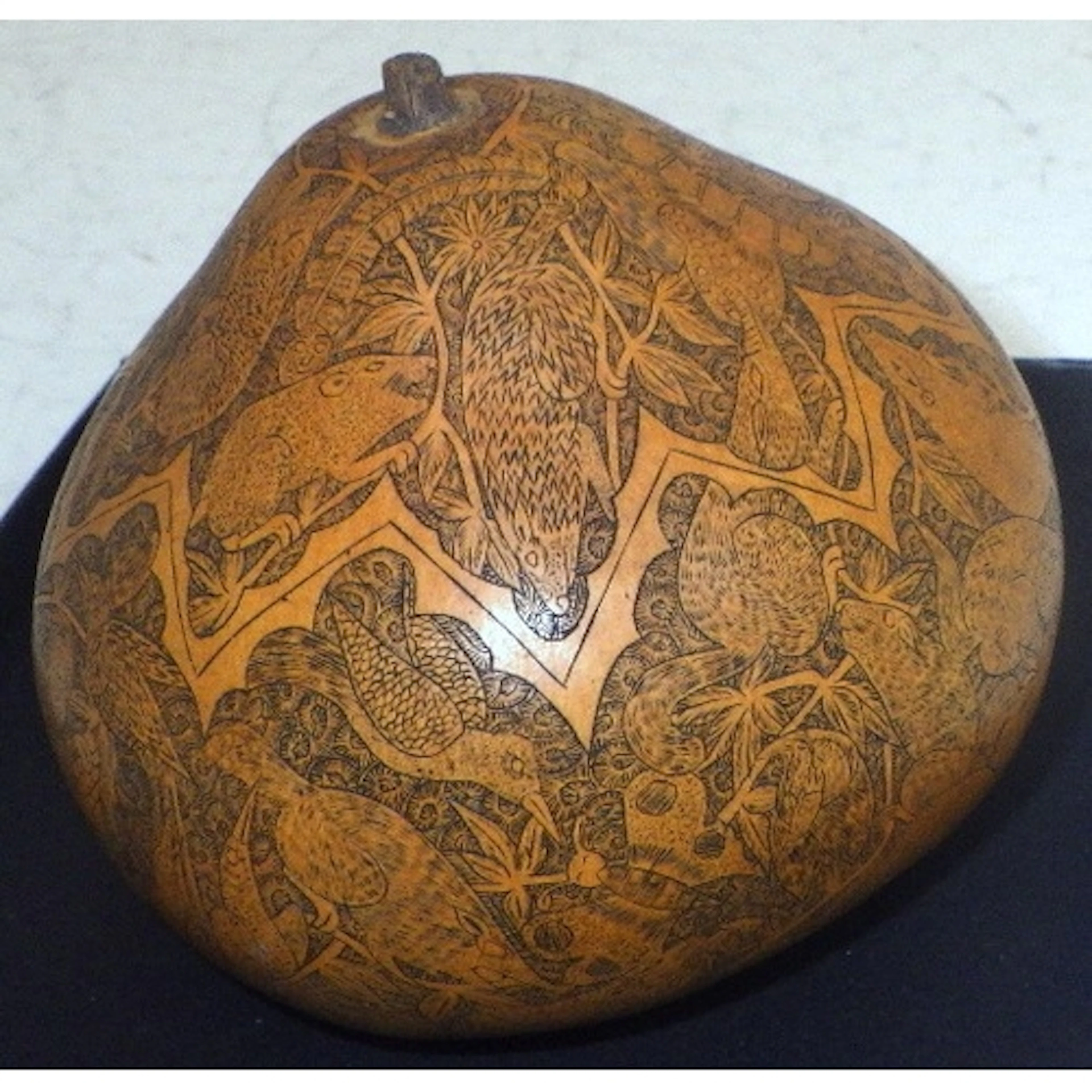 A Peruvian carved gourd