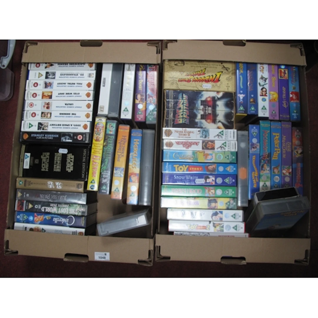 Collection of vintage VHS tapes, featuring Disney animated c...