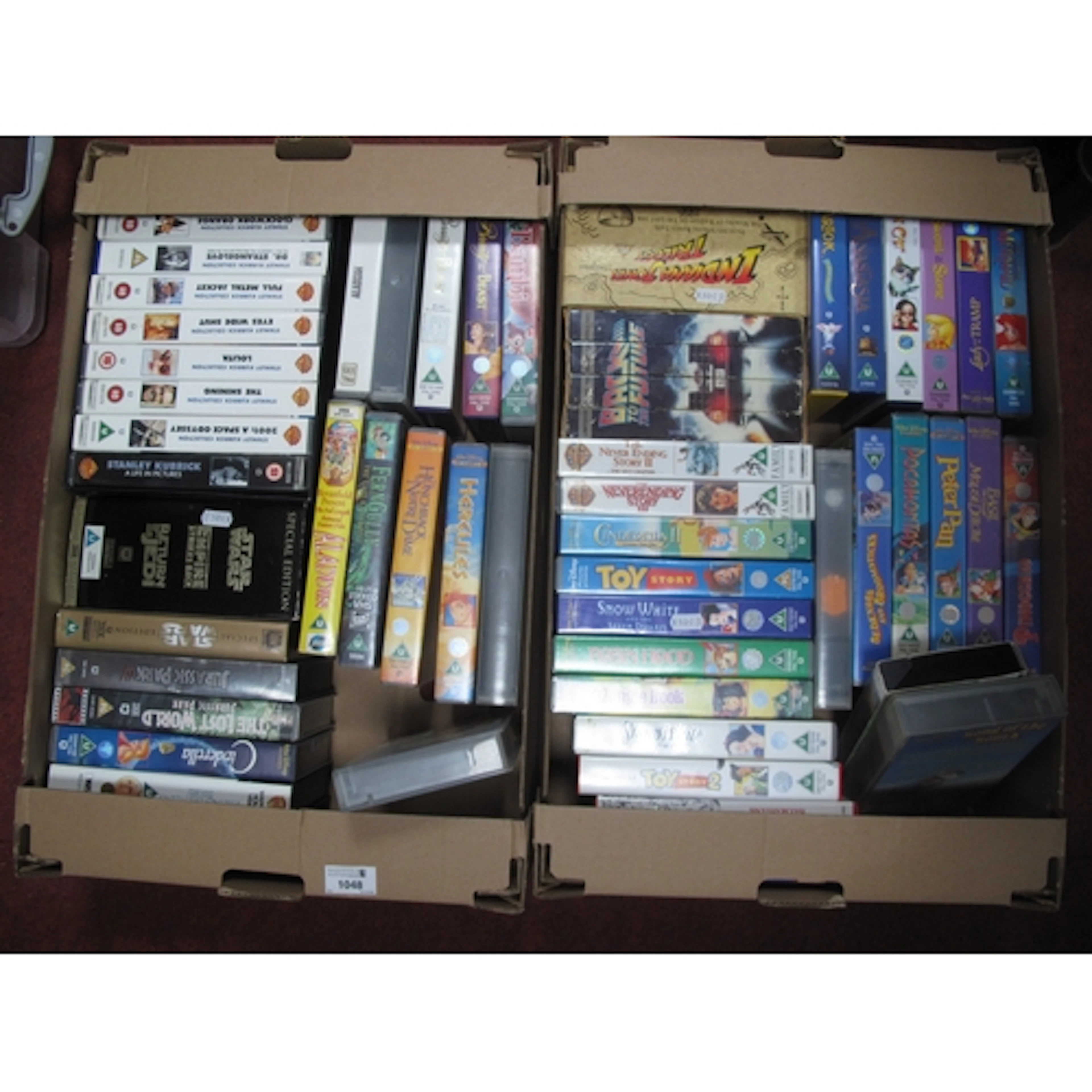 Collection of vintage VHS tapes, featuring Disney animated c...