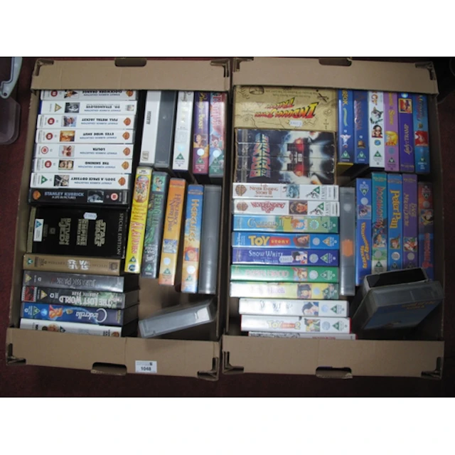 Collection of vintage VHS tapes, featuring Disney animated c...