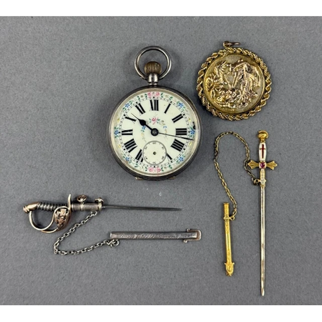 Jewellery: a yellow metal jabot pin modelled as a sword, unm...