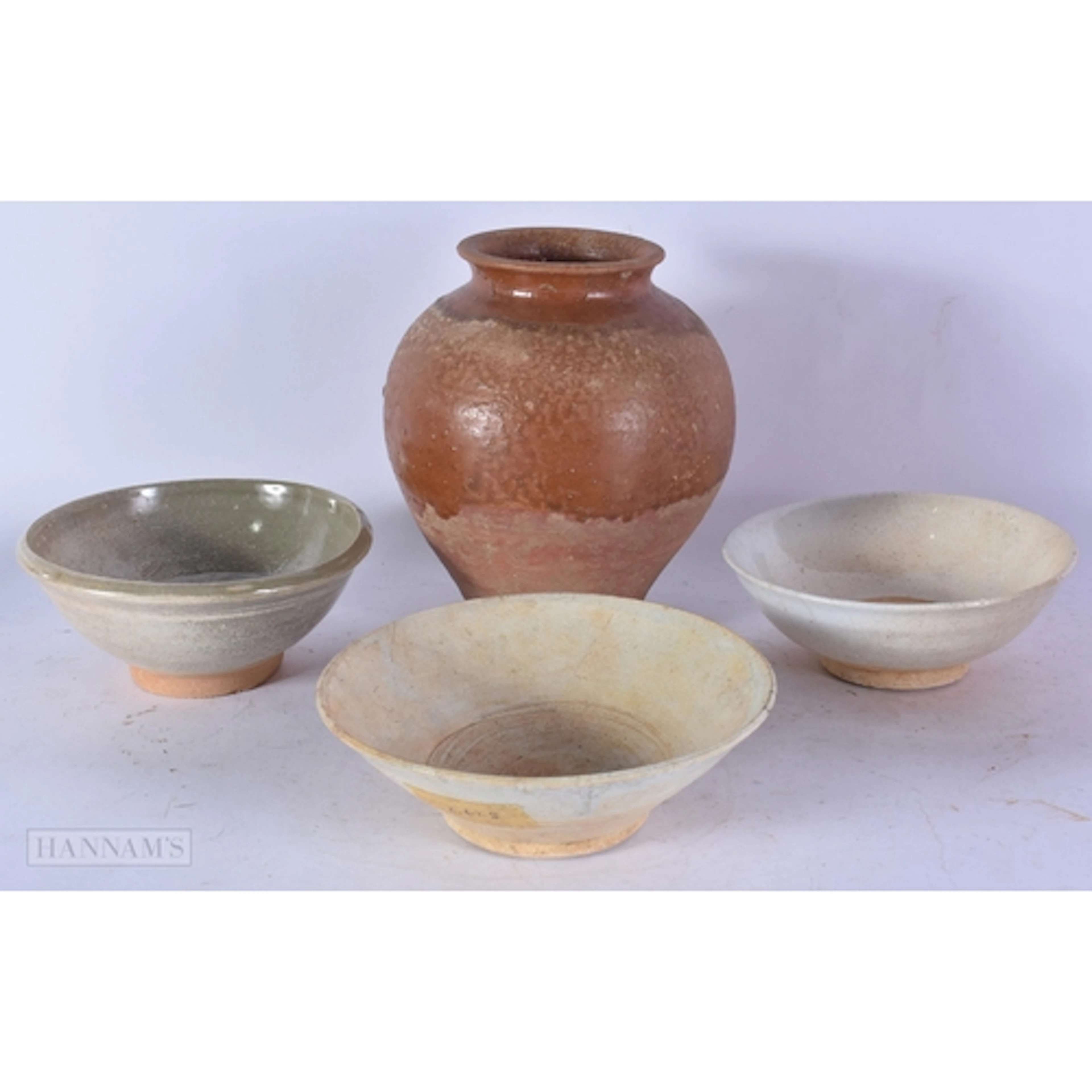 A CHINESE HAN DYNASTY VASE and three Sung bowls. Largest 18 ...