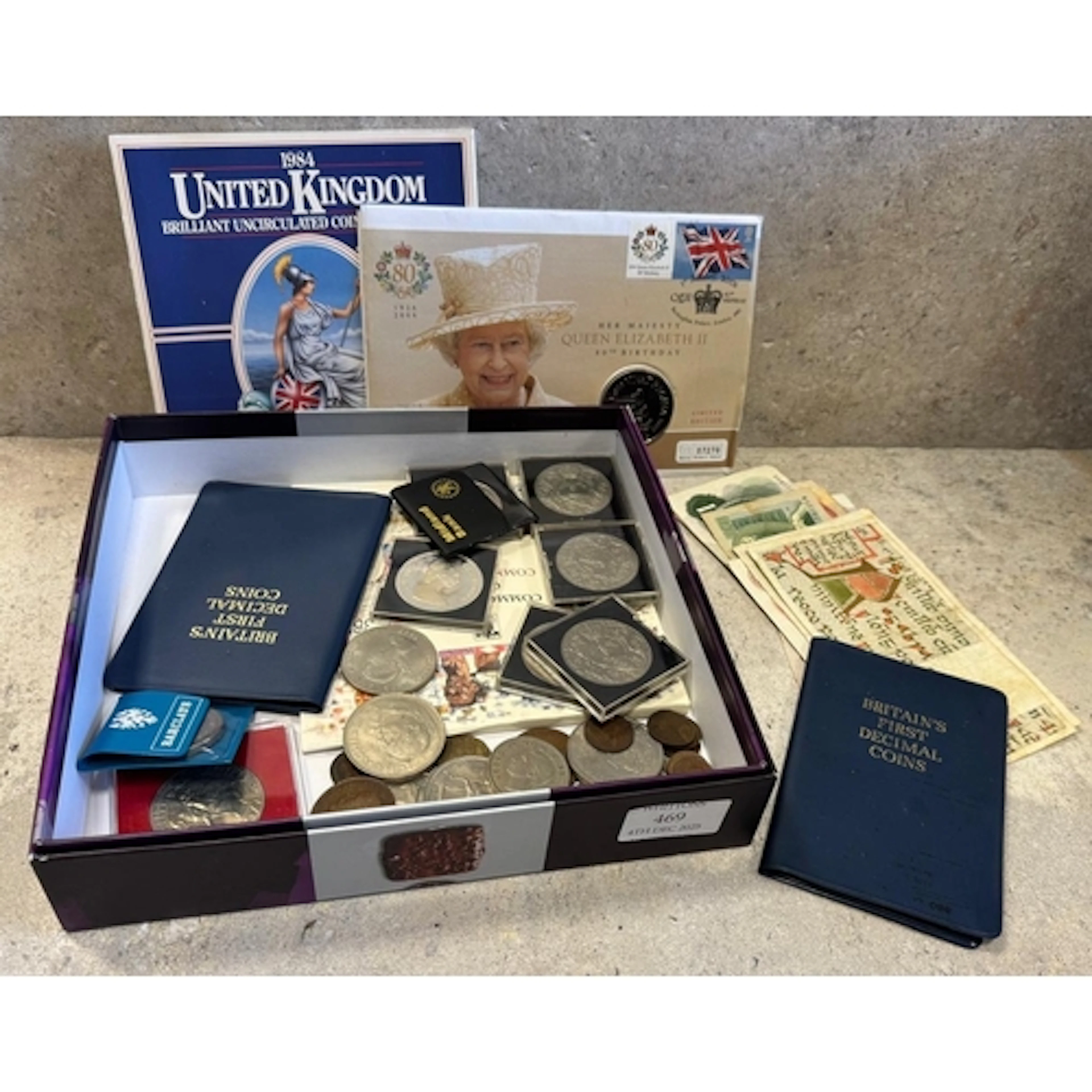 A box containing Proof and other decimal coins and paper mon...