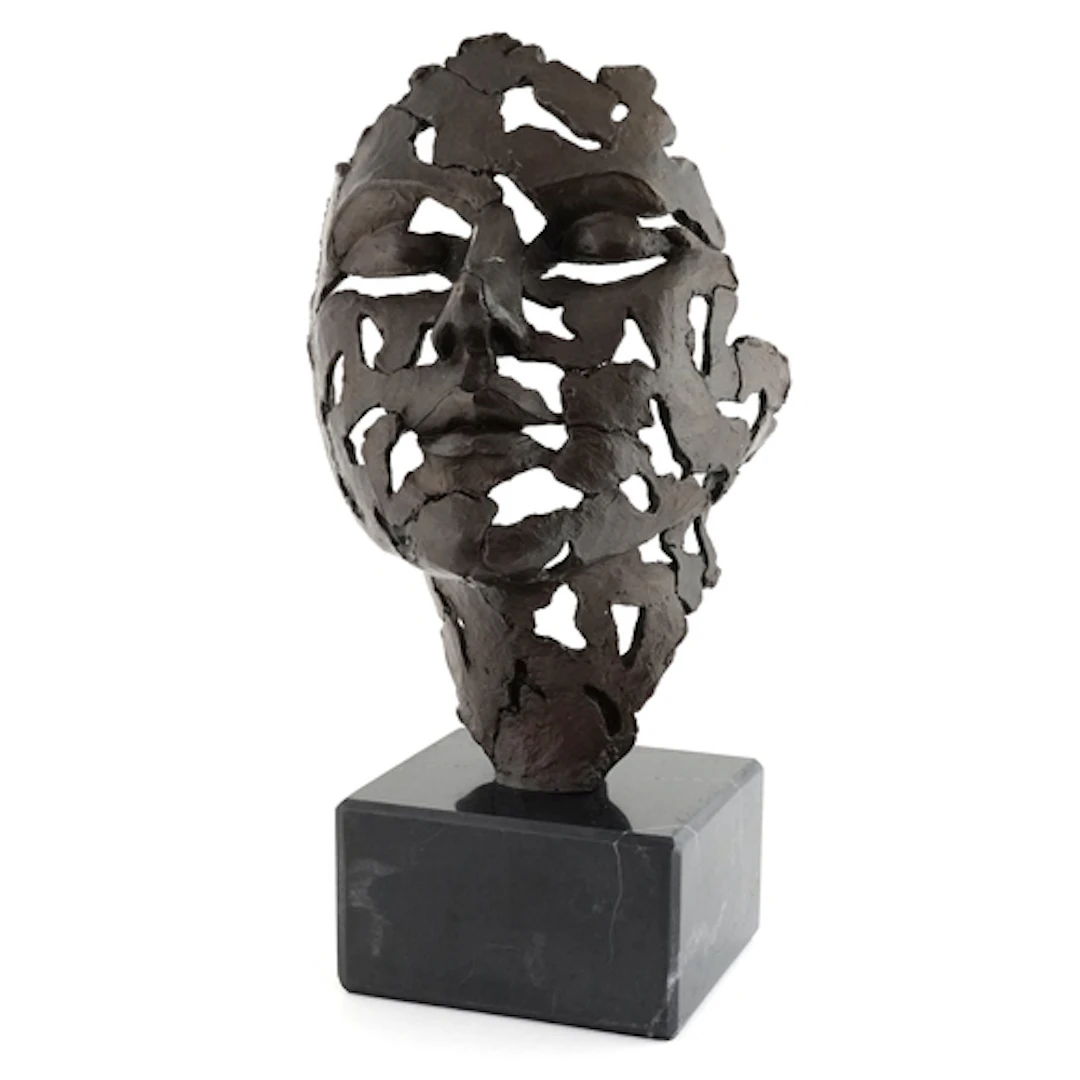 Patinated bronze sculpture of an abstract style face mask, r...