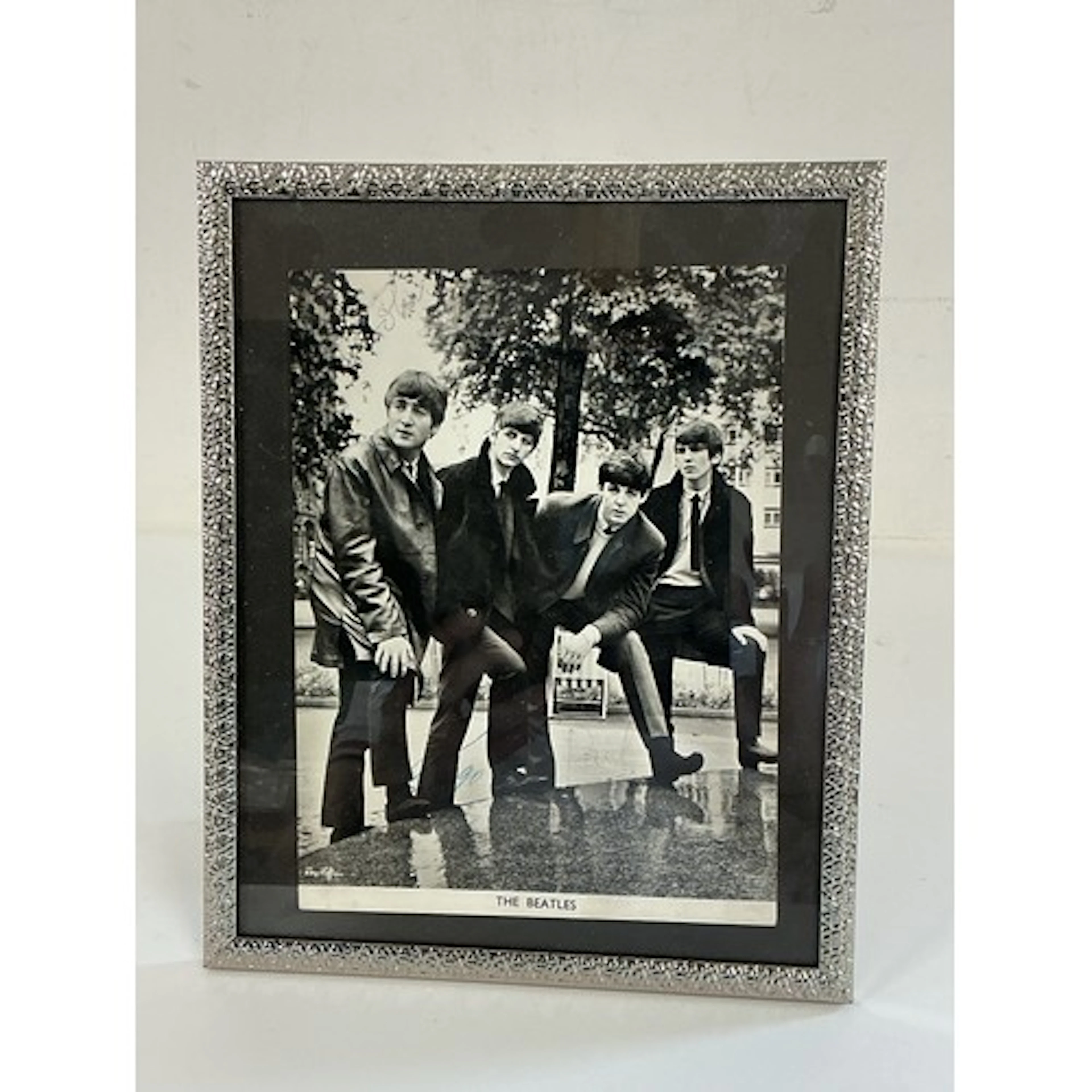 A signed Beatles publicity card. Unusually signed with just ...