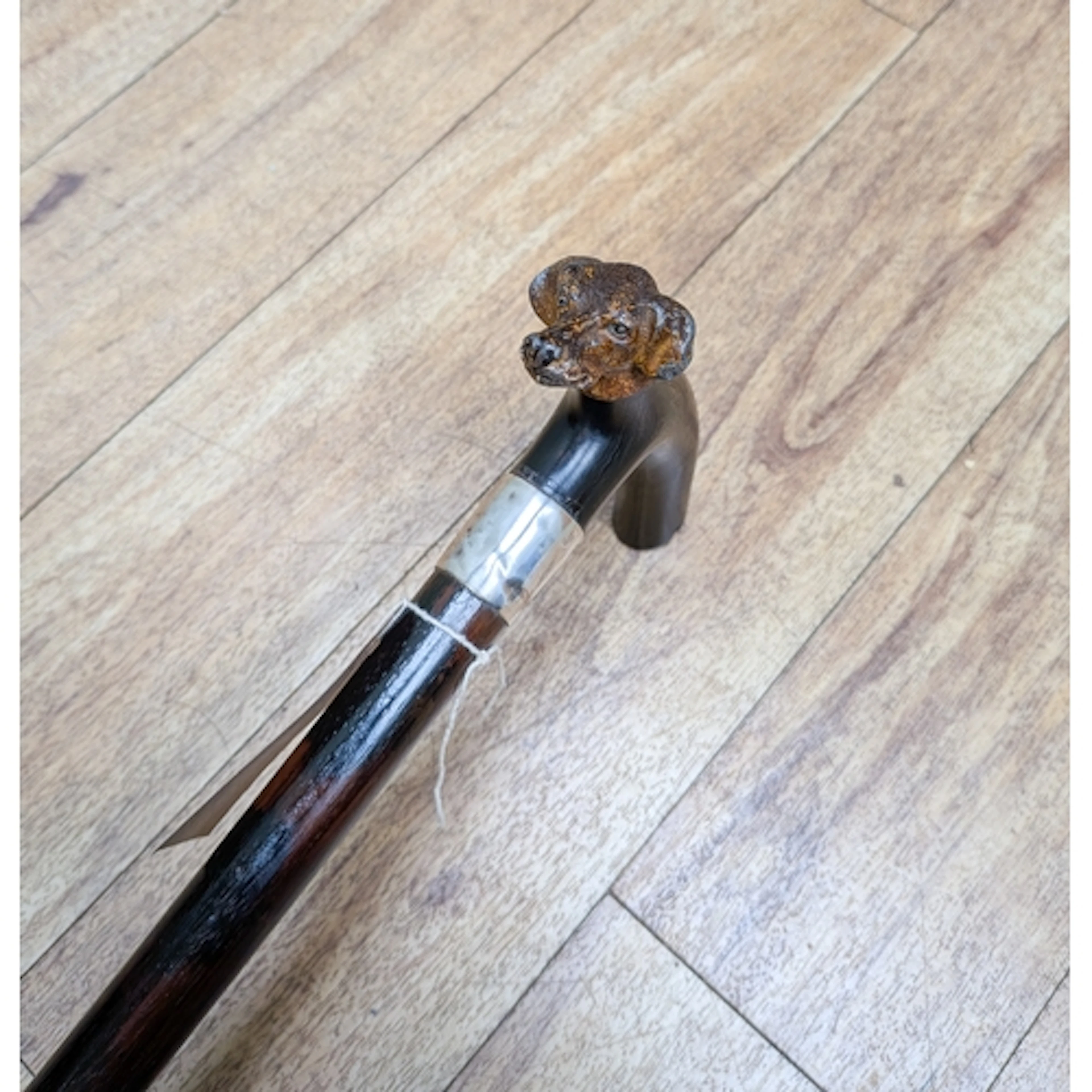 A silver mounted walking cane with cold painted terrier dog ...