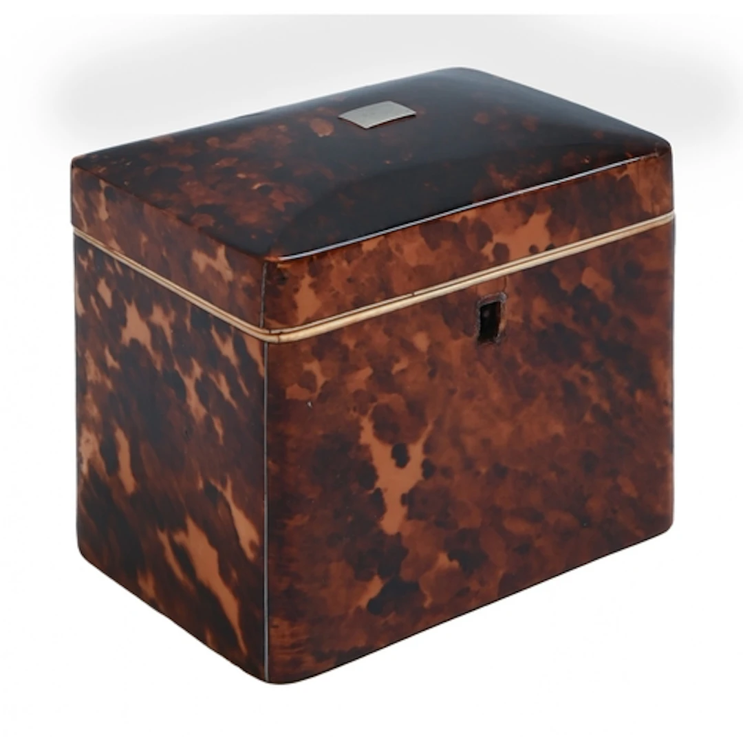 An early Victorian tortoiseshell tea caddy, the hinged lid w...