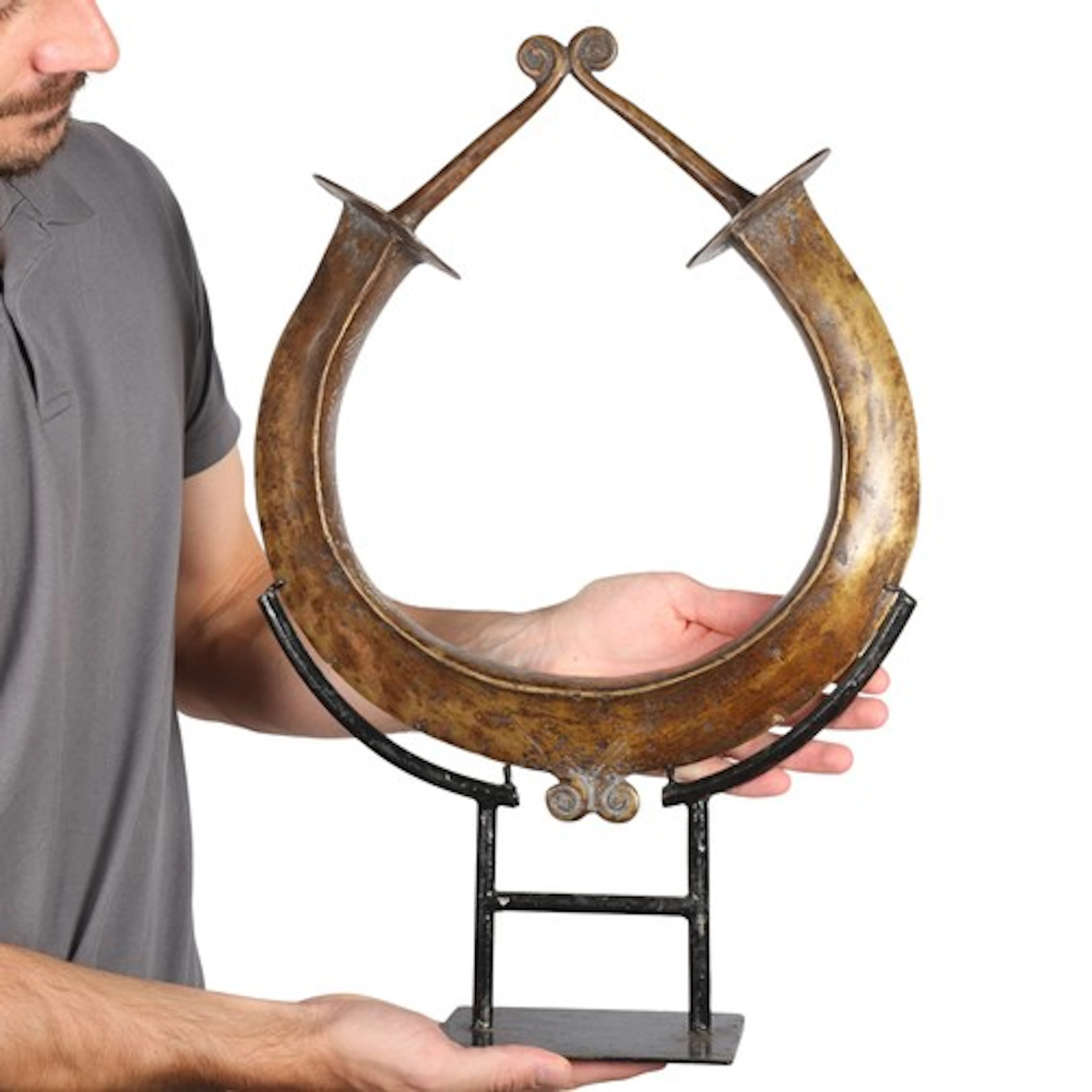 A Yoruba bronze torque currency, on metal stand, overall hei...