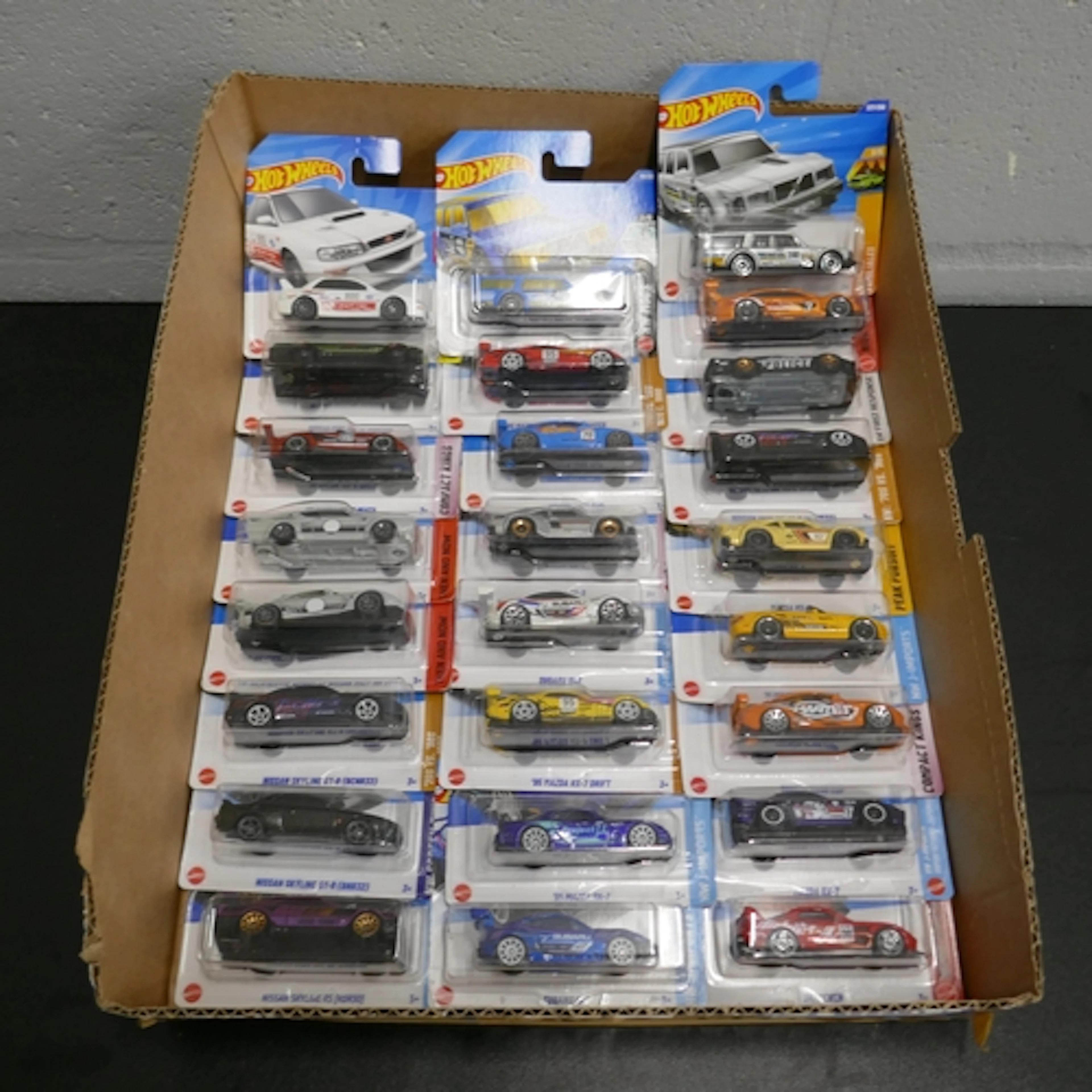 Twenty-Five Hotwheels Mainline toy cars including, Nissan Sk...