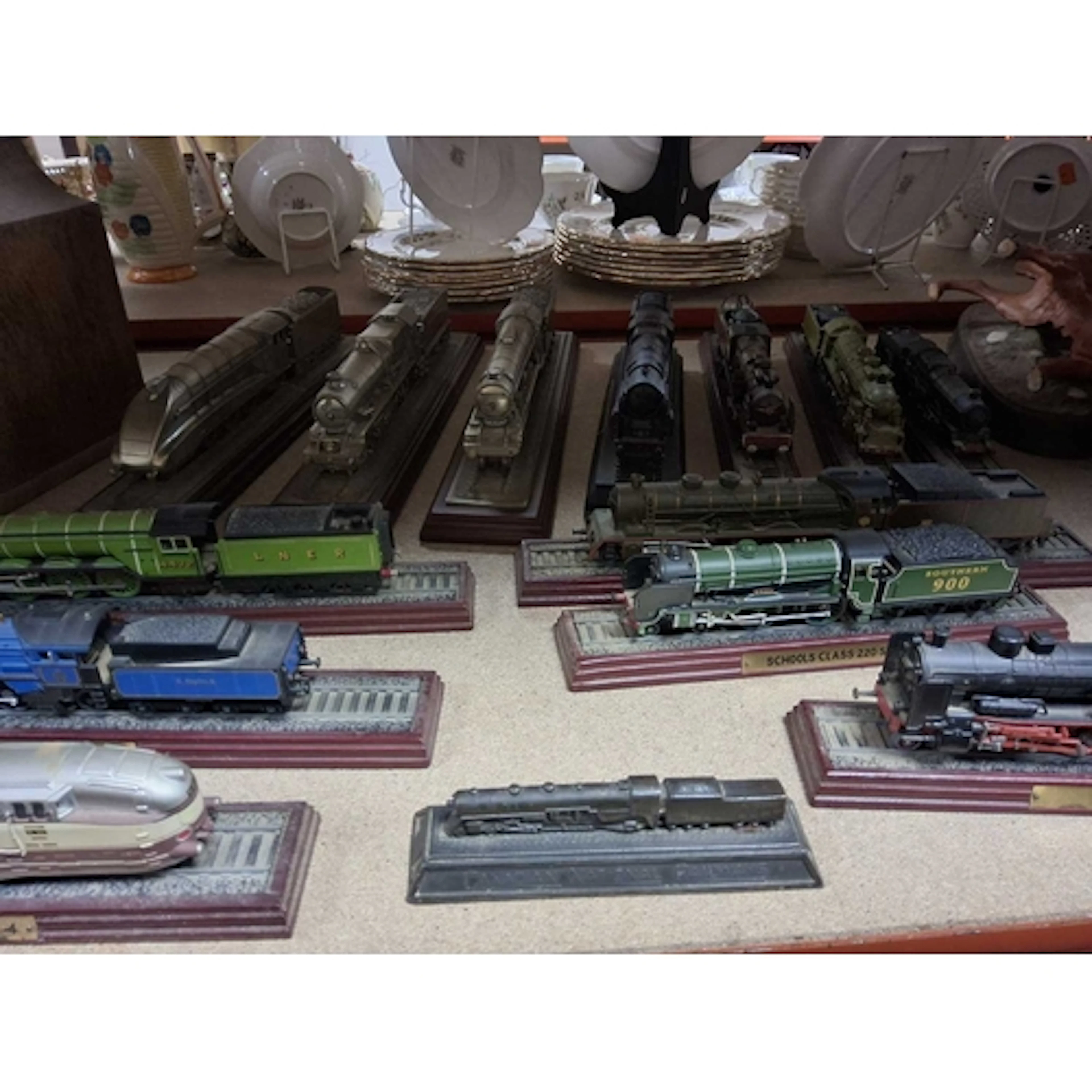 A COLLECTION OF MODEL TRAINS all mounted on plinths, compris...