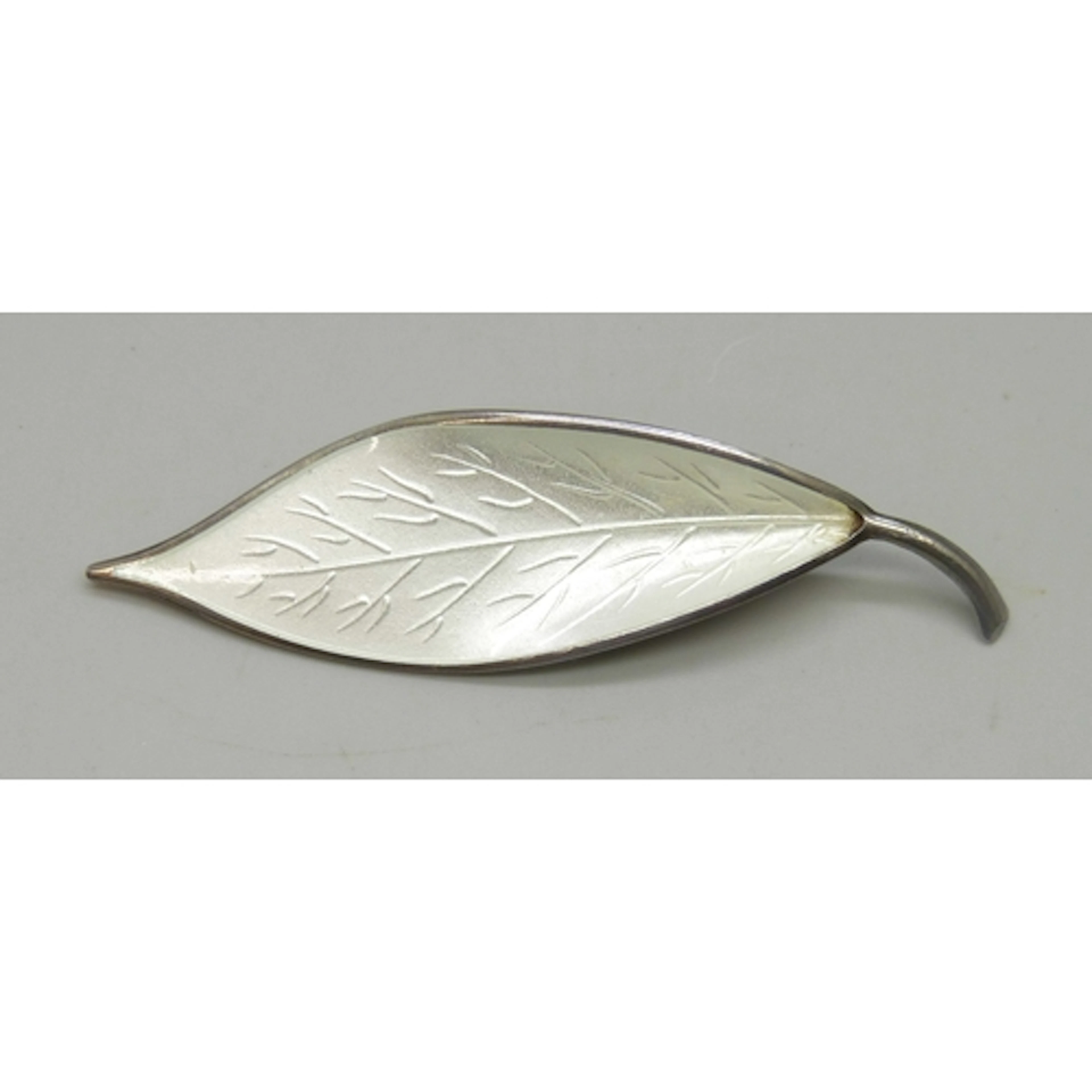 David Andersen, a Norwegian silver and white enamel leaf bro...