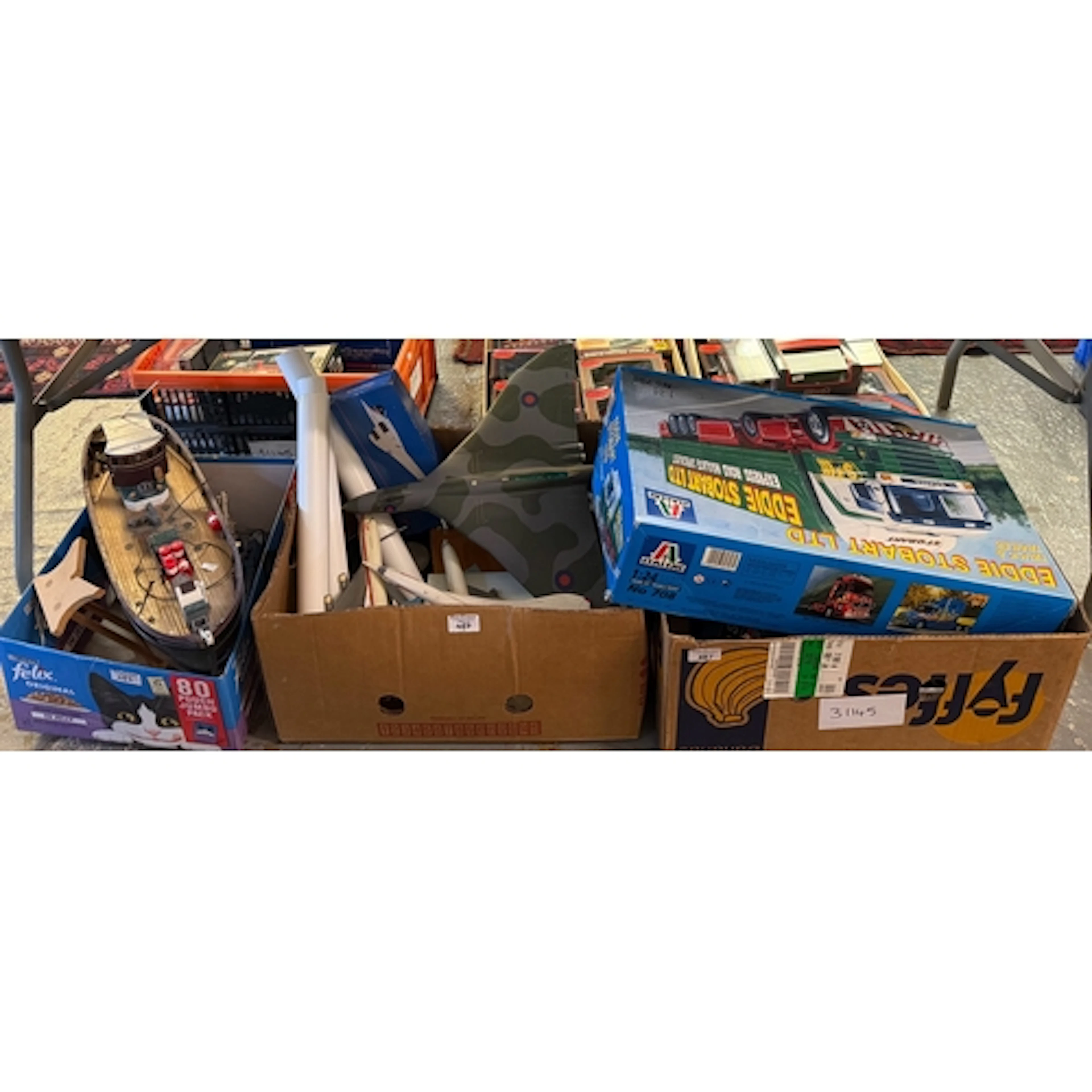 Three boxes of toy related items to include: Eddie Stobart L...