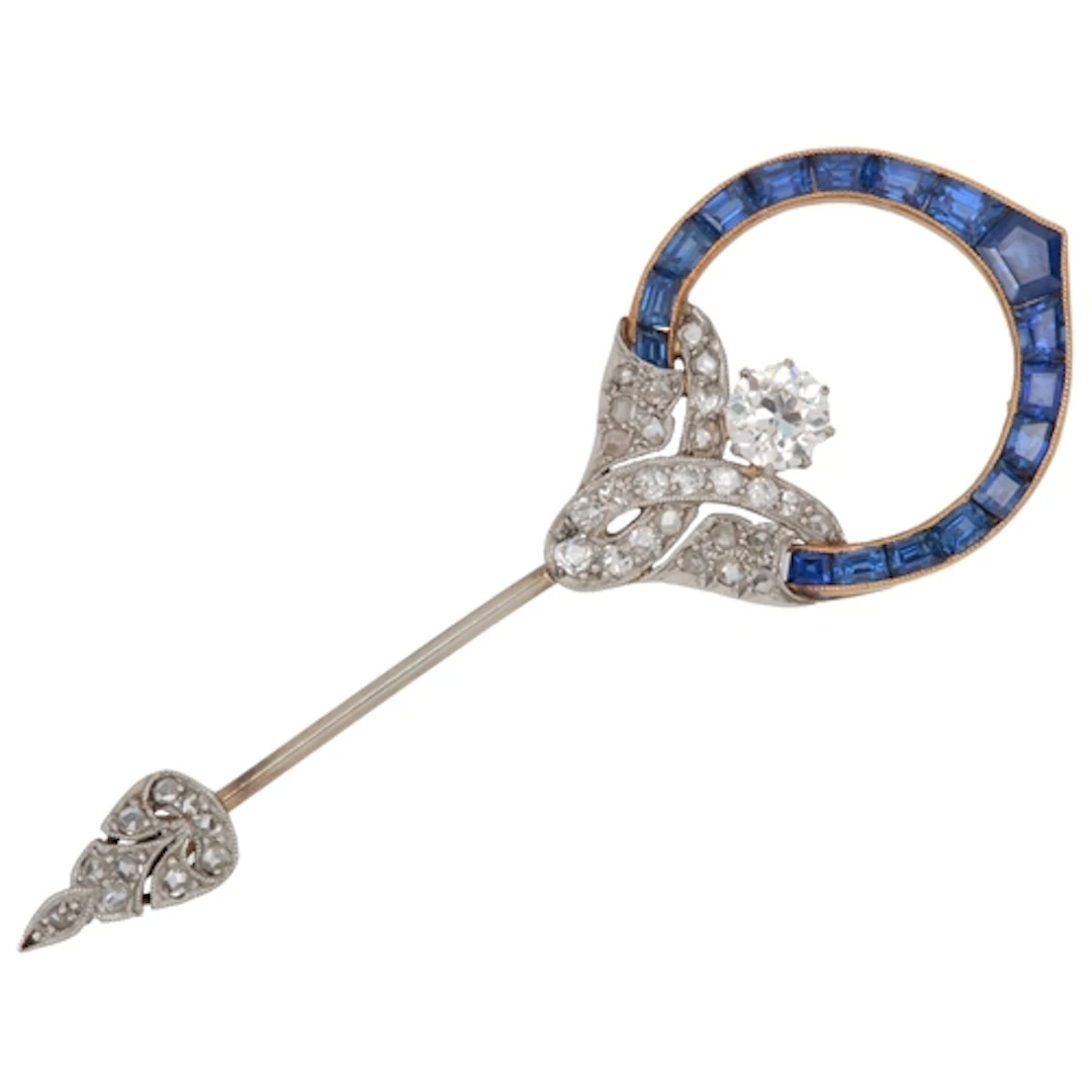 An Art Deco sapphire and diamond jabot pin, 1920s, of scroll...