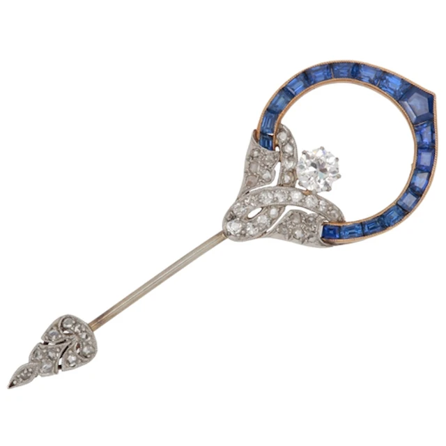 An Art Deco sapphire and diamond jabot pin, 1920s, of scroll...