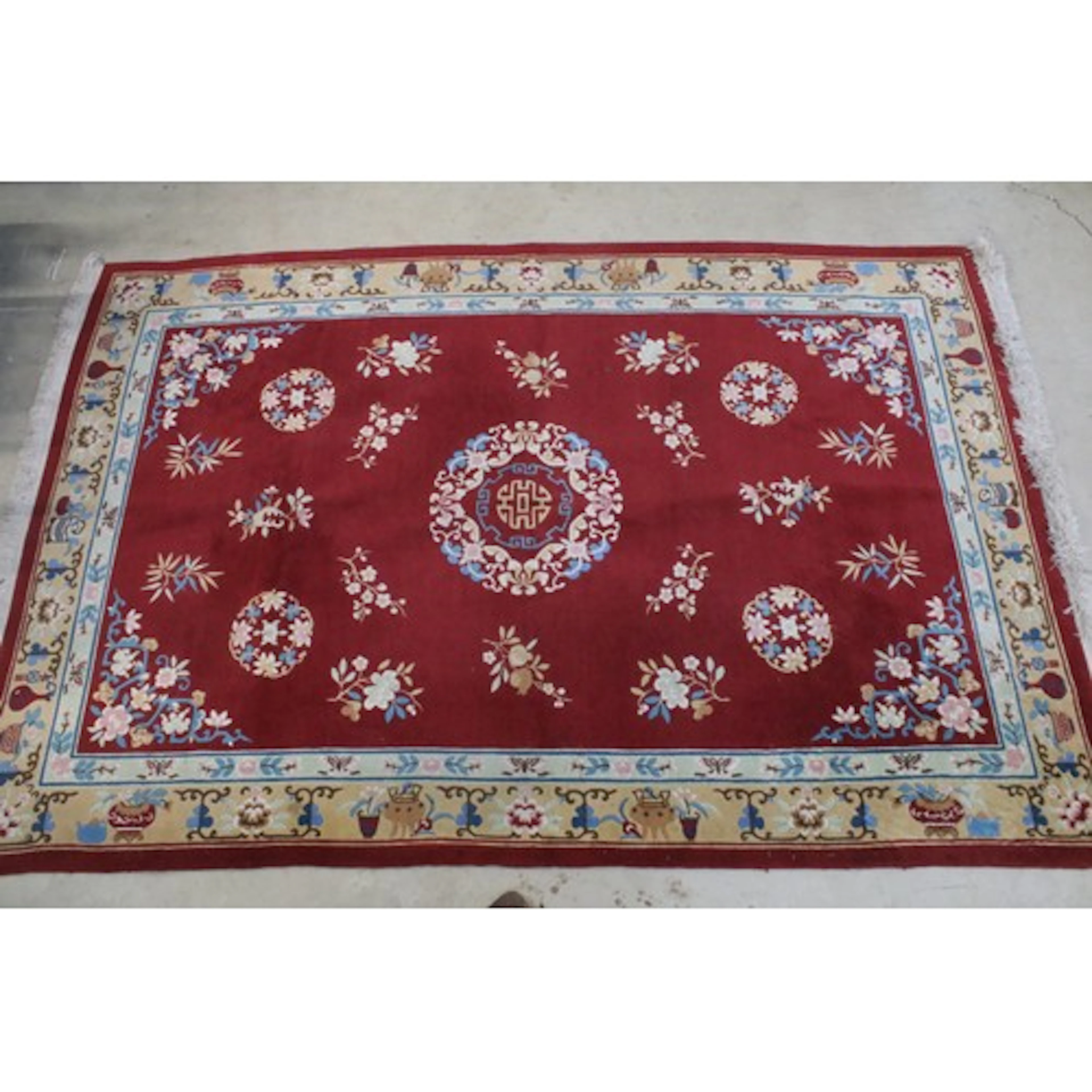 Large Chinese red-ground rug, having central zhou mark medal...