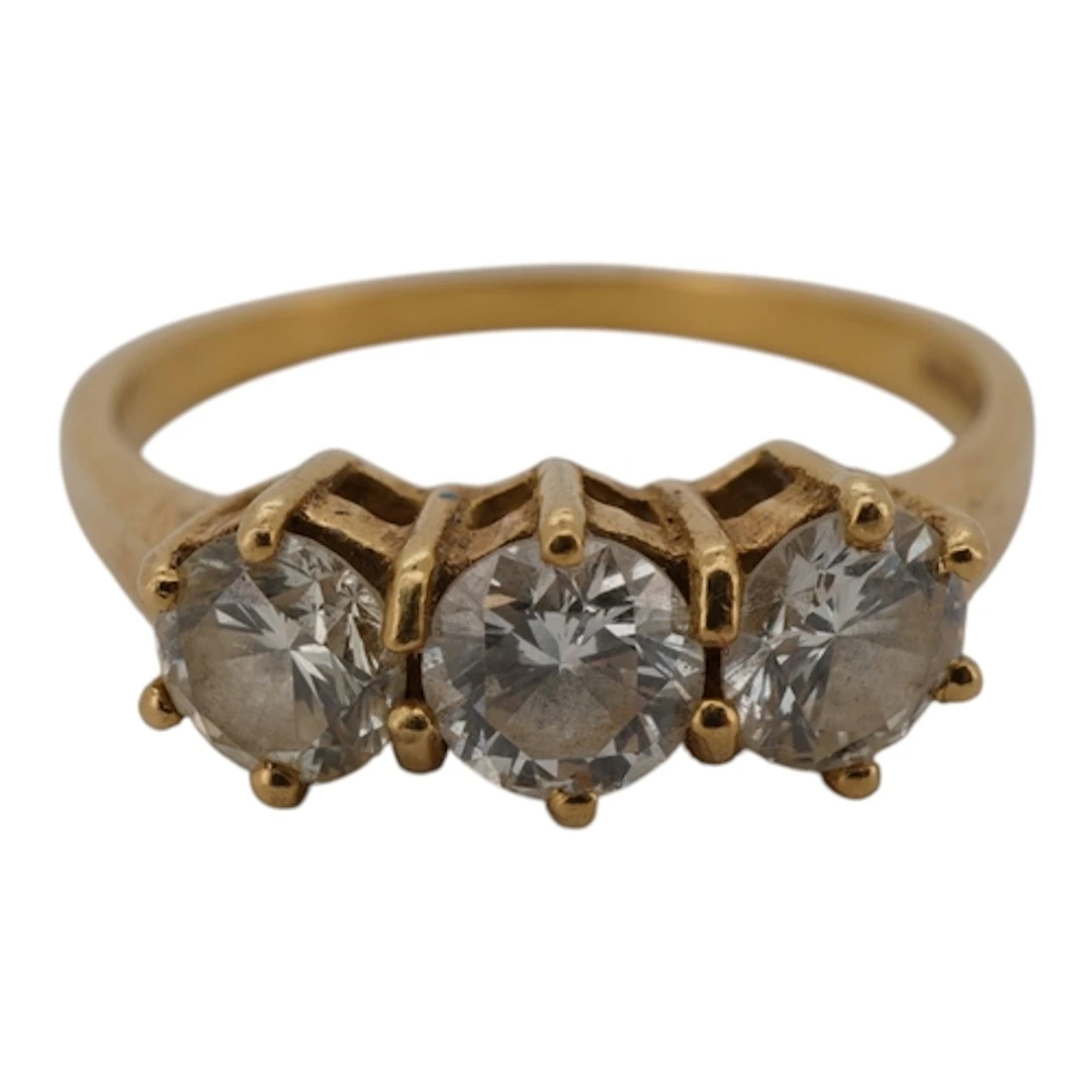 A three-stone diamond ring, set with three brilliant-cut dia...