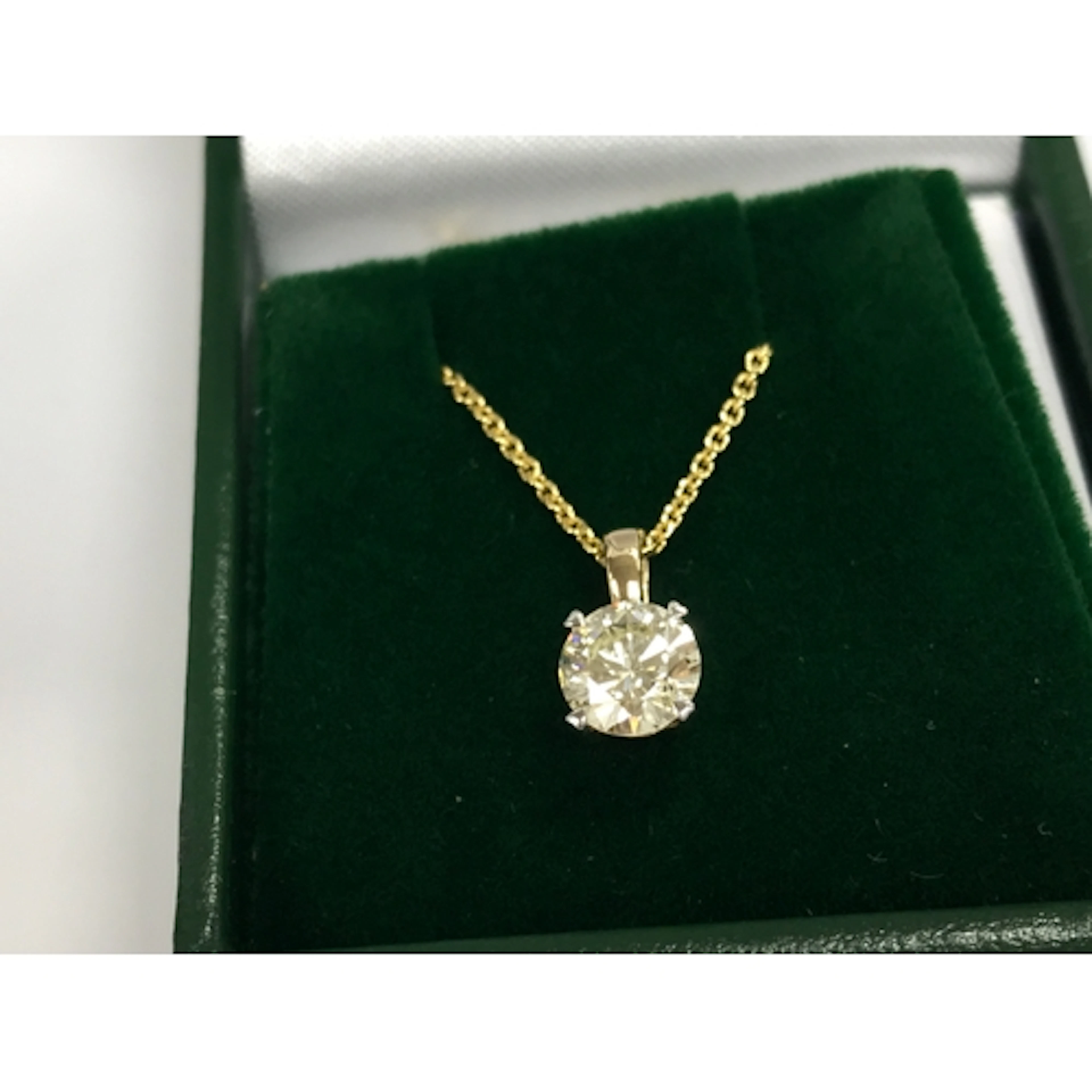 14ct gold round diamond solitaire pendant on a plated silver...