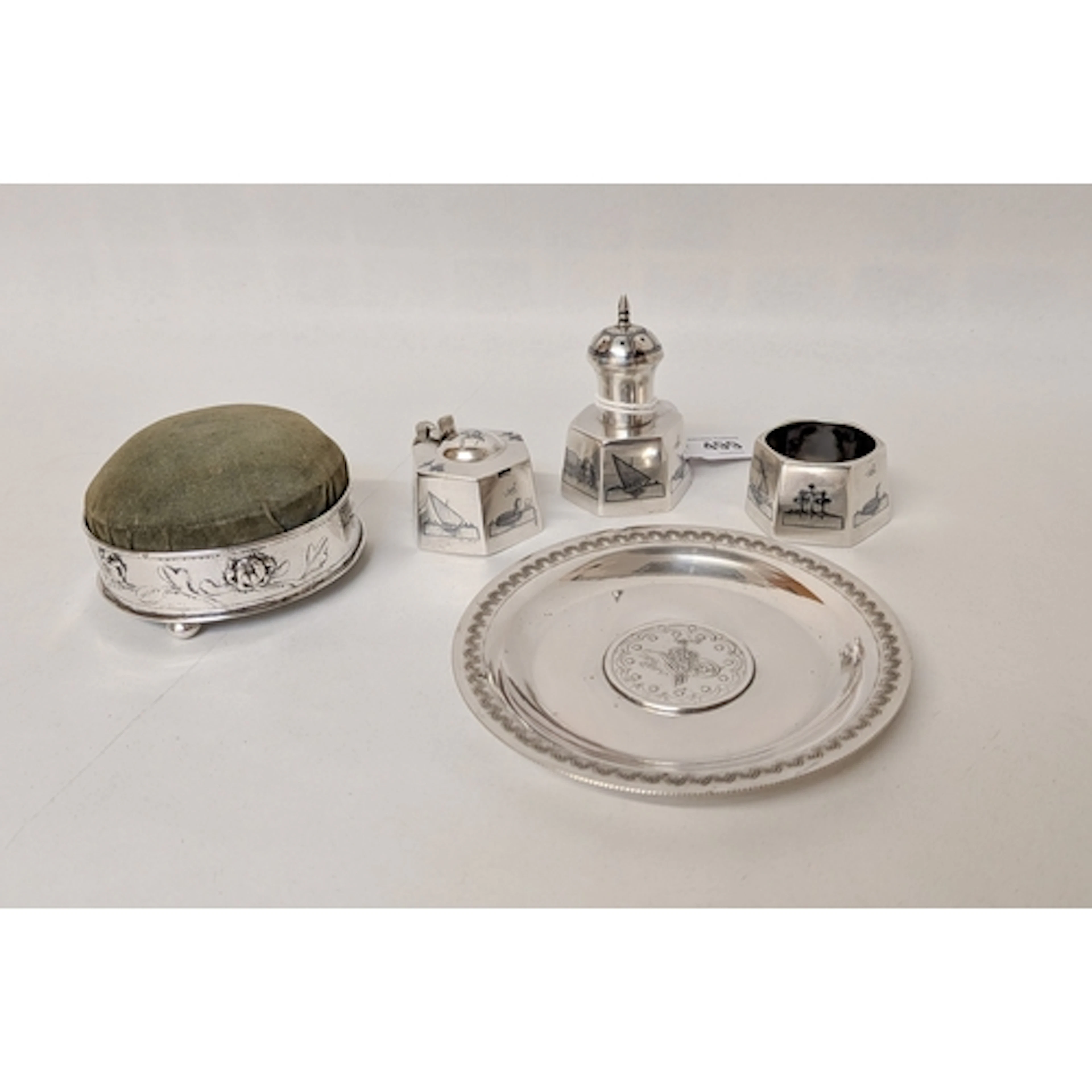 A Chinese silver circular pin cushion, a Persian silver coin...