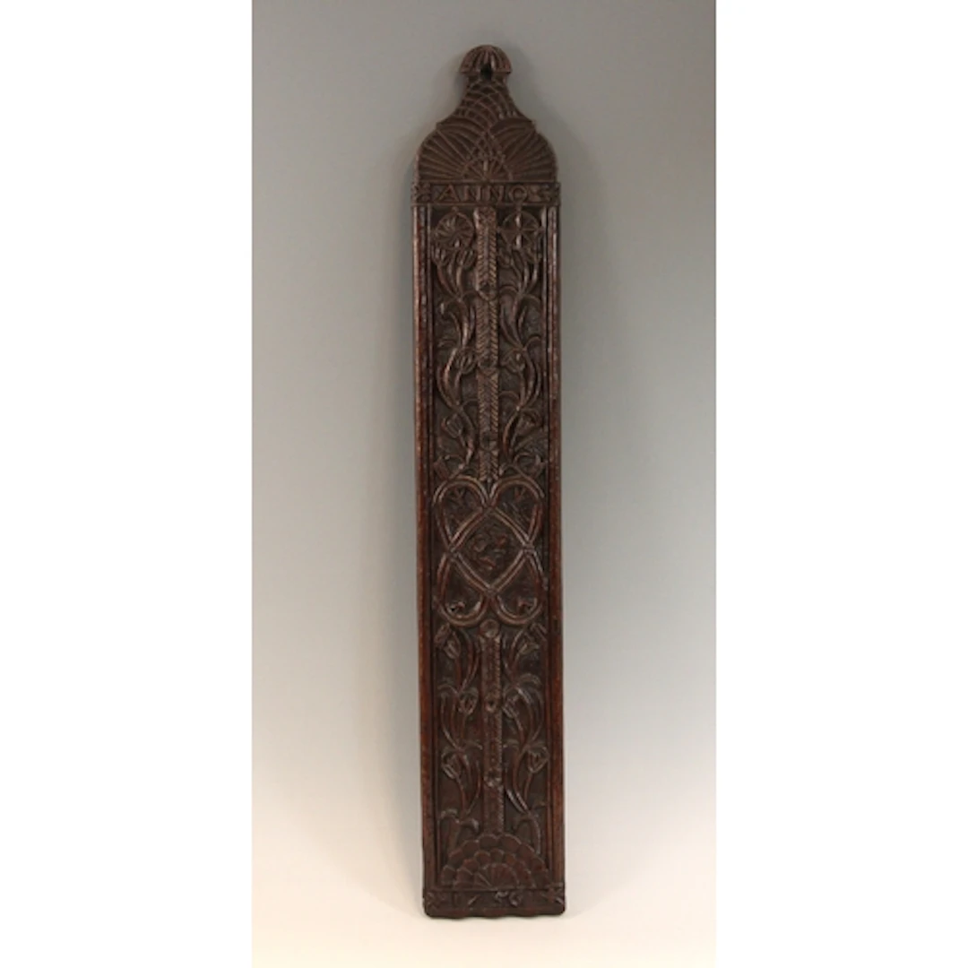 An 18th century style oak wash board, bas-relief carved to o...