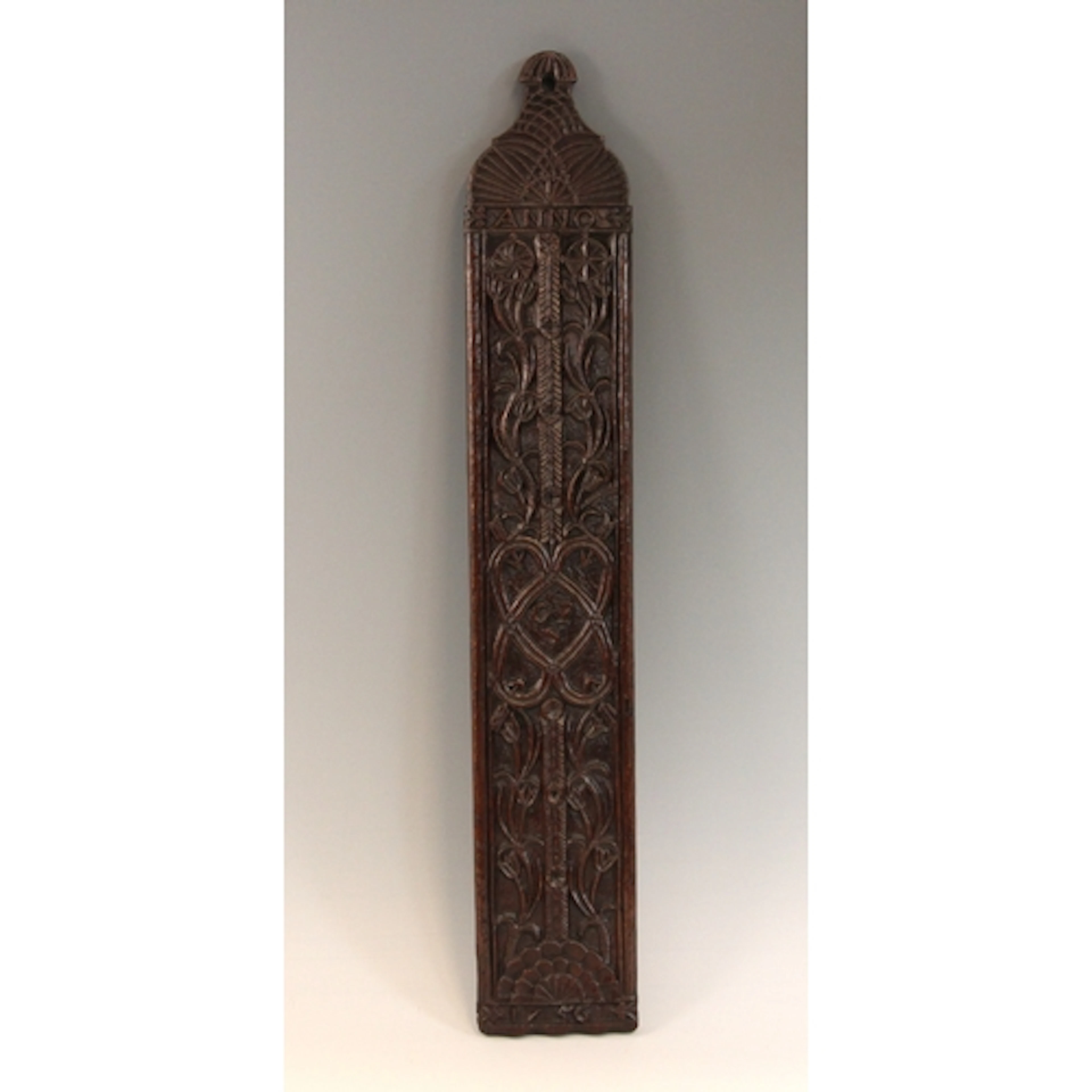 An 18th century style oak wash board, bas-relief carved to o...