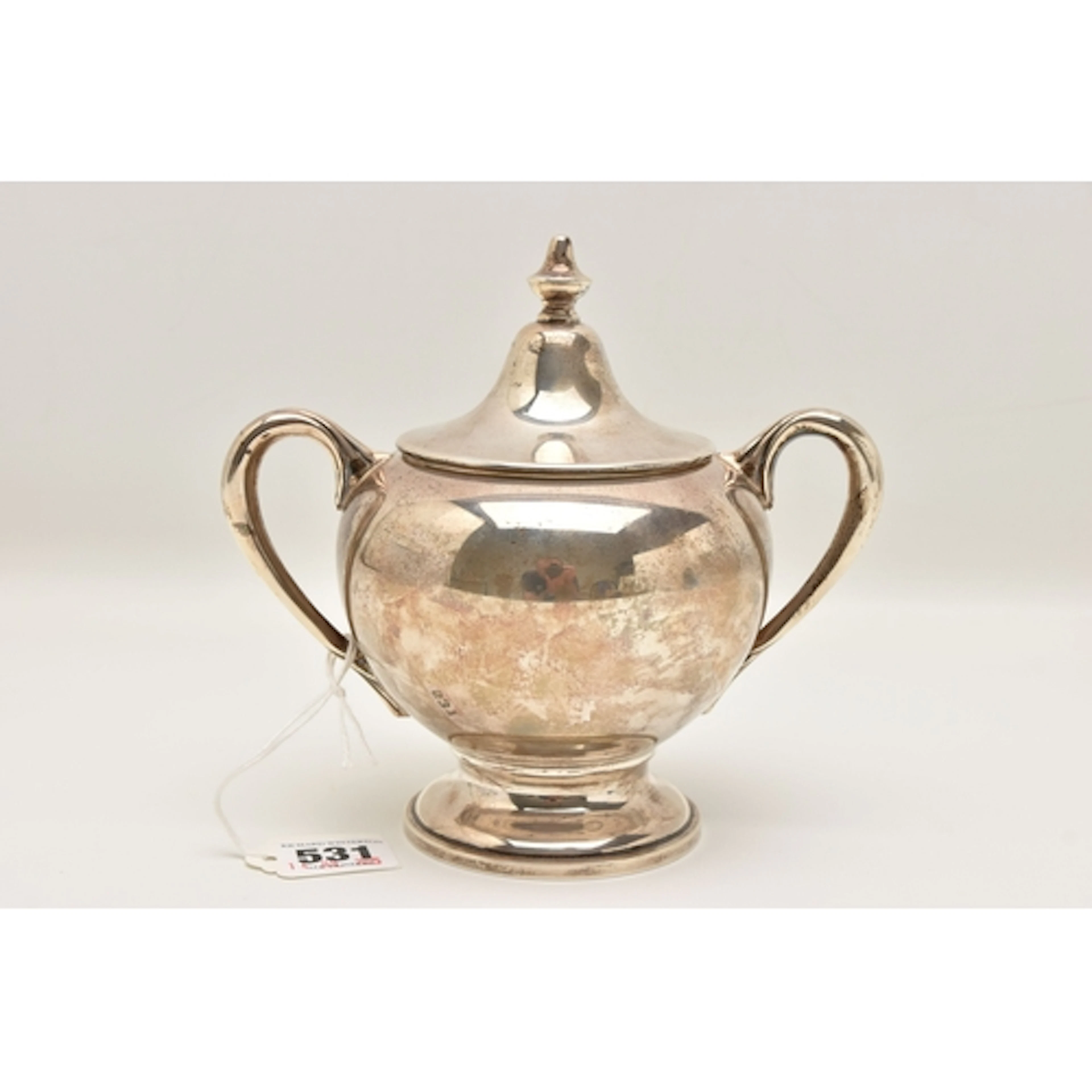 A CONTINETAL WHITE METAL SUGAR BOWL, polished form fitted wi...