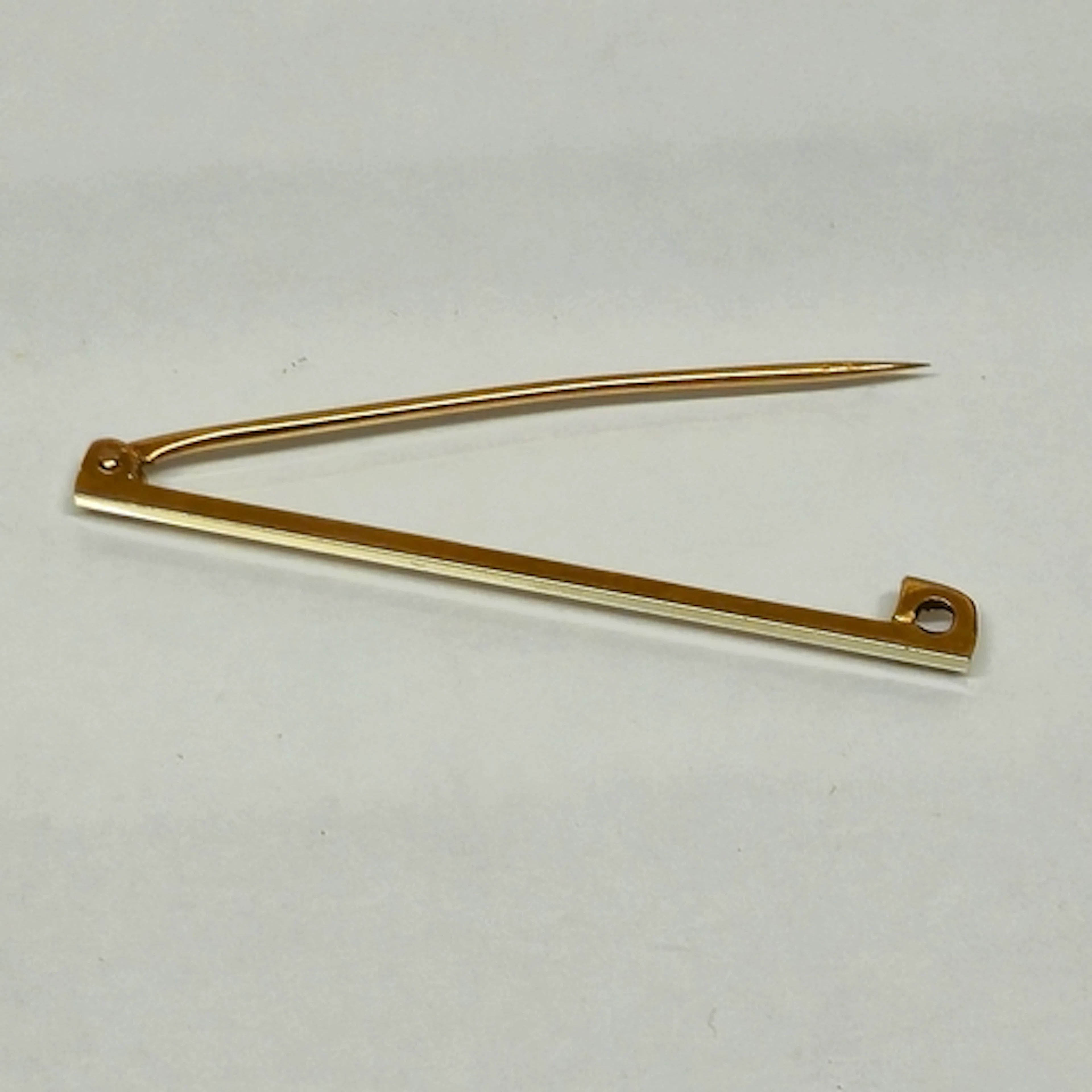 18ct white gold and 9ct yellow gold safety pin brooch, marke...